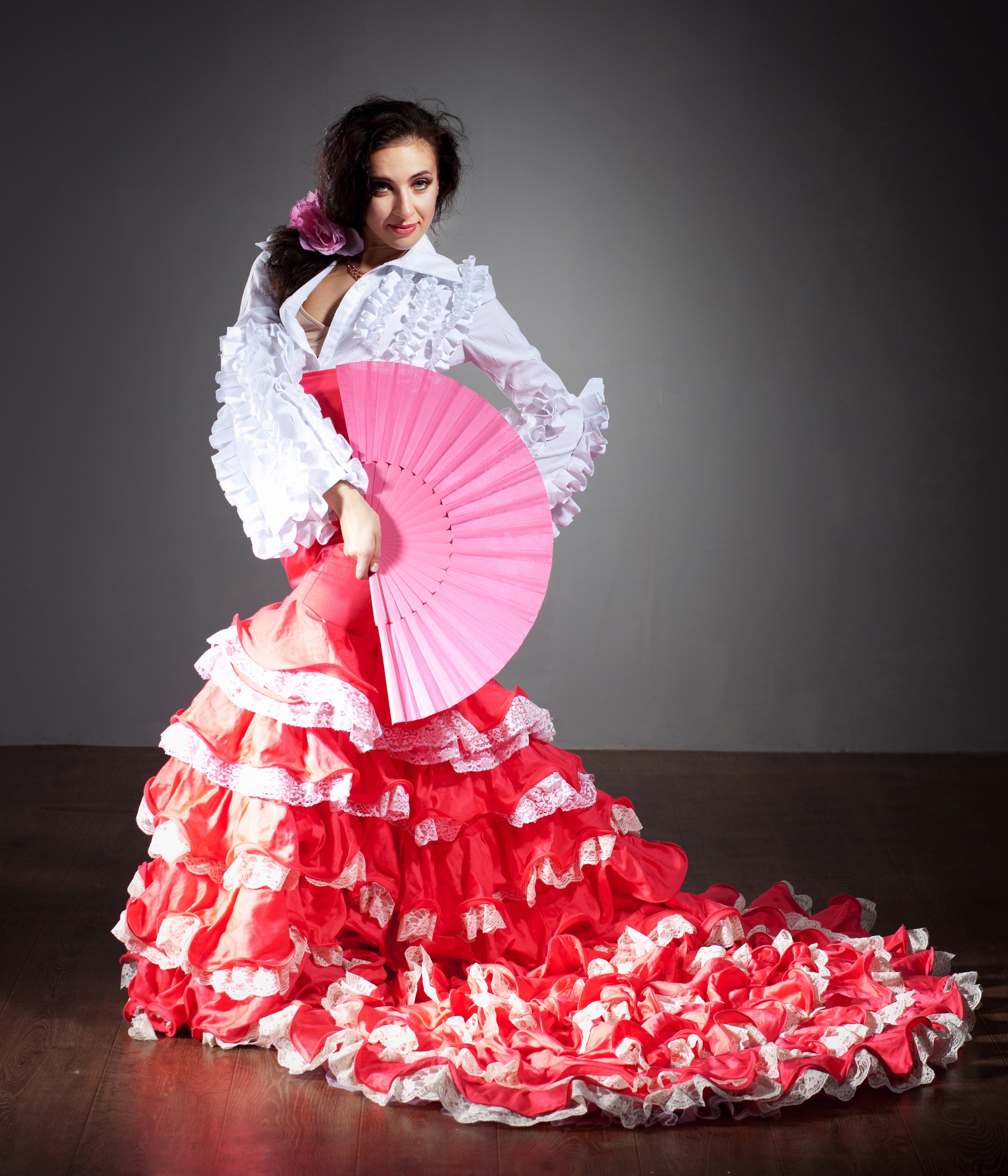 Flamenco dancer in red dress holding pink fan HD Wallpaper