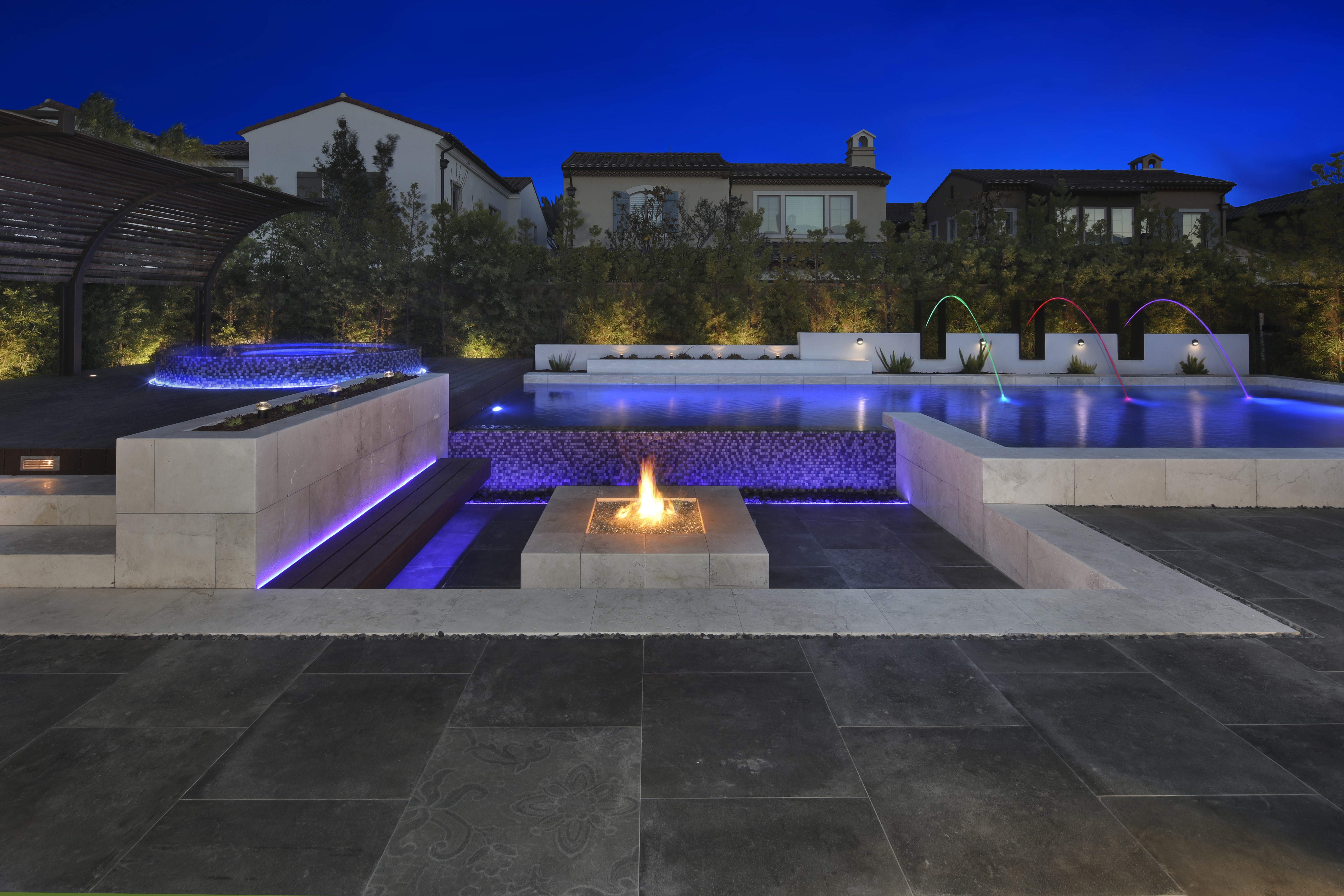 Luxury Backyard with Pool, Fire Pit, and Fountains at Night HD Wallpaper