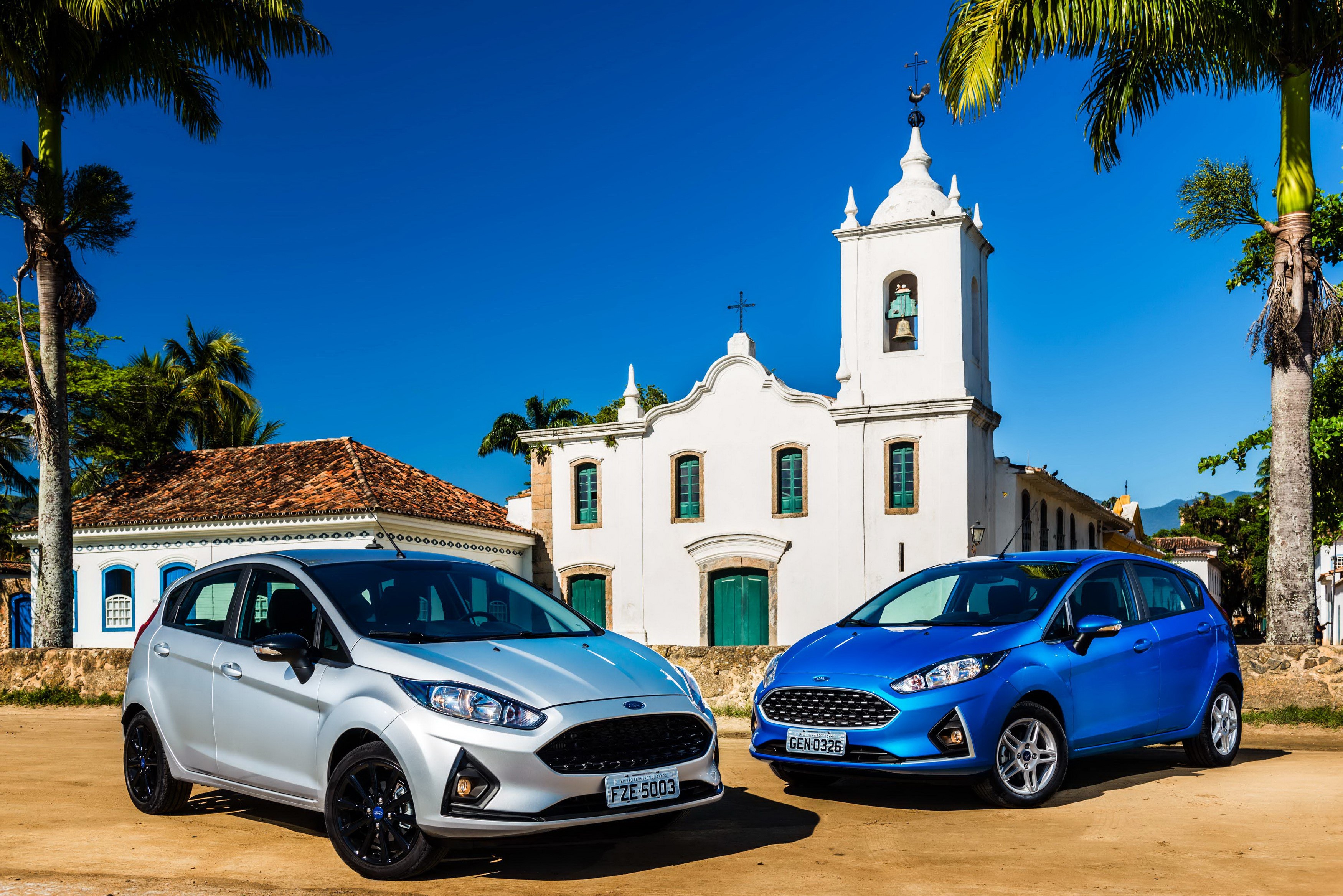 Two Ford Fiesta cars in front of a white church HD Wallpaper