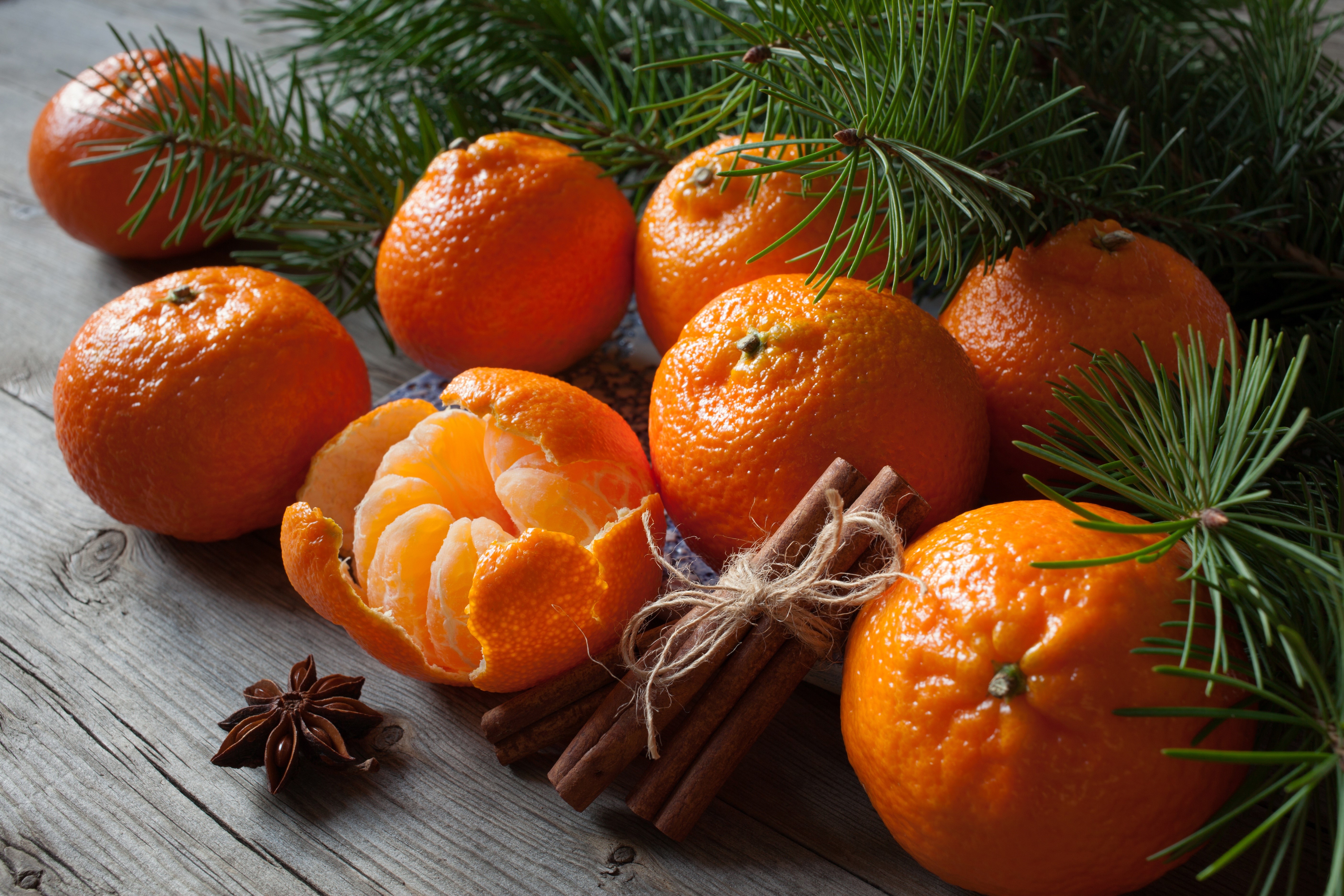 Tangerines with pine branches, cinnamon sticks, and star anise HD Wallpaper