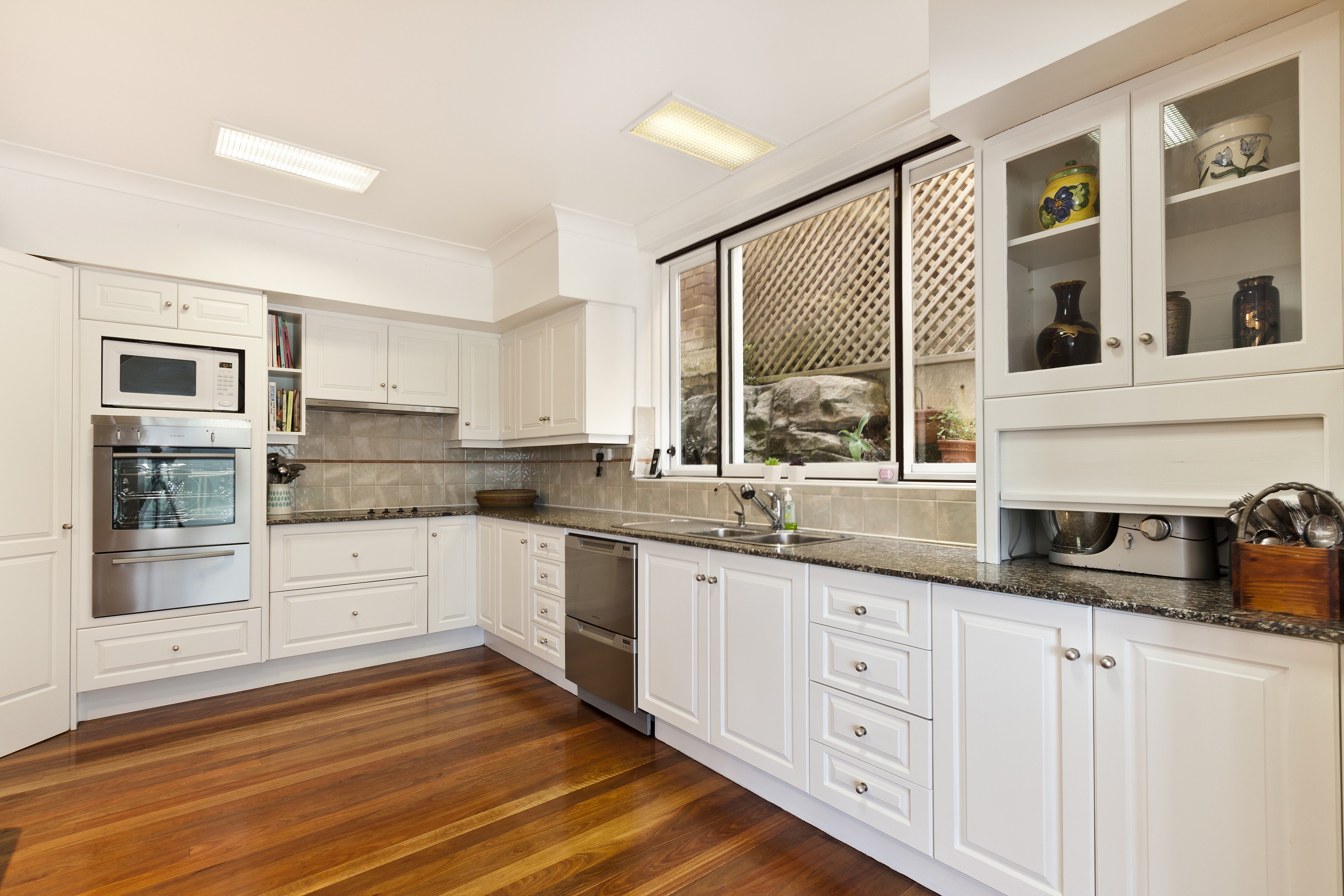 Modern Kitchen with White Cabinets and Hardwood Floors HD Wallpaper