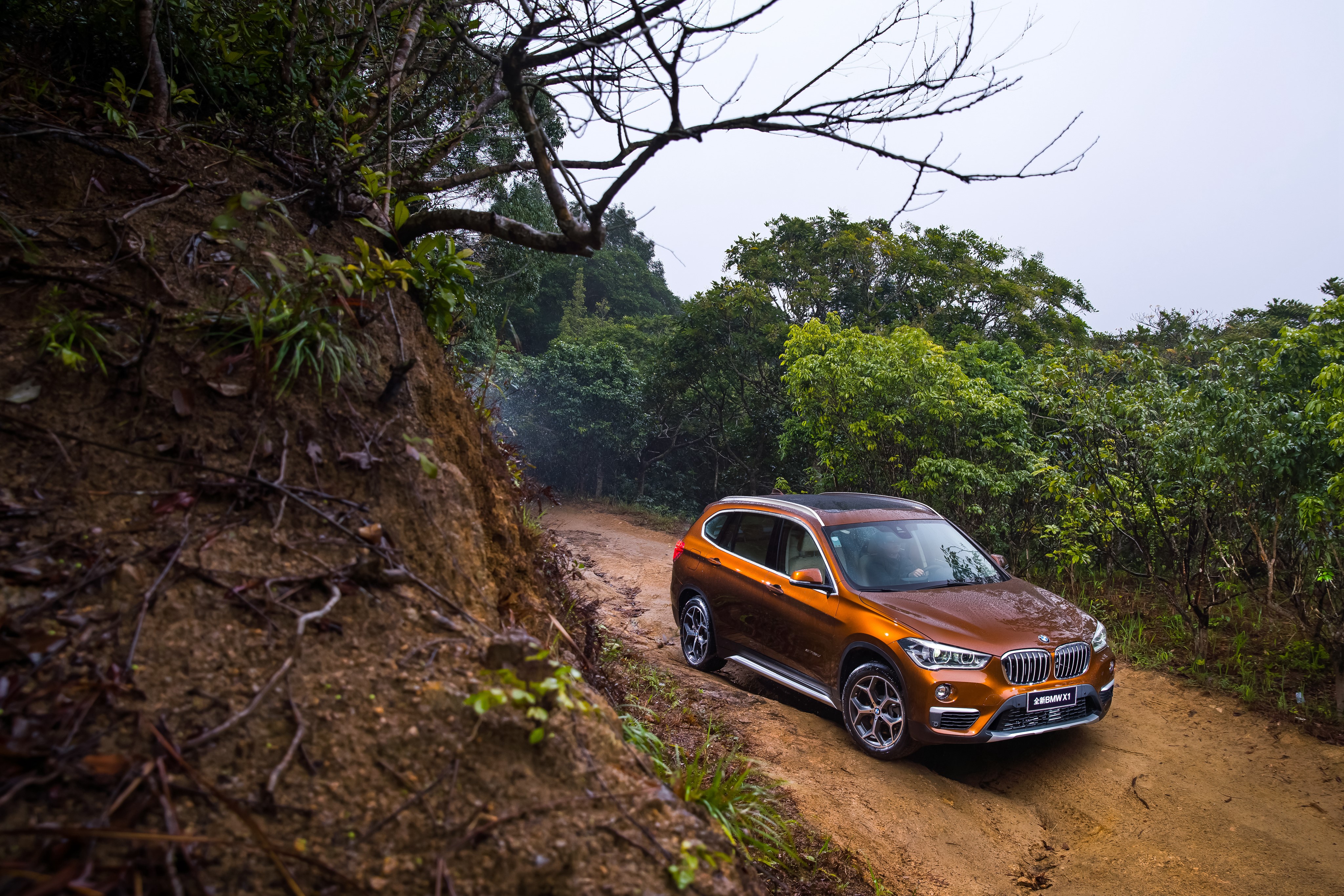 2016 BMW X1 xDrive25Li xLine on a dirt road HD Wallpaper