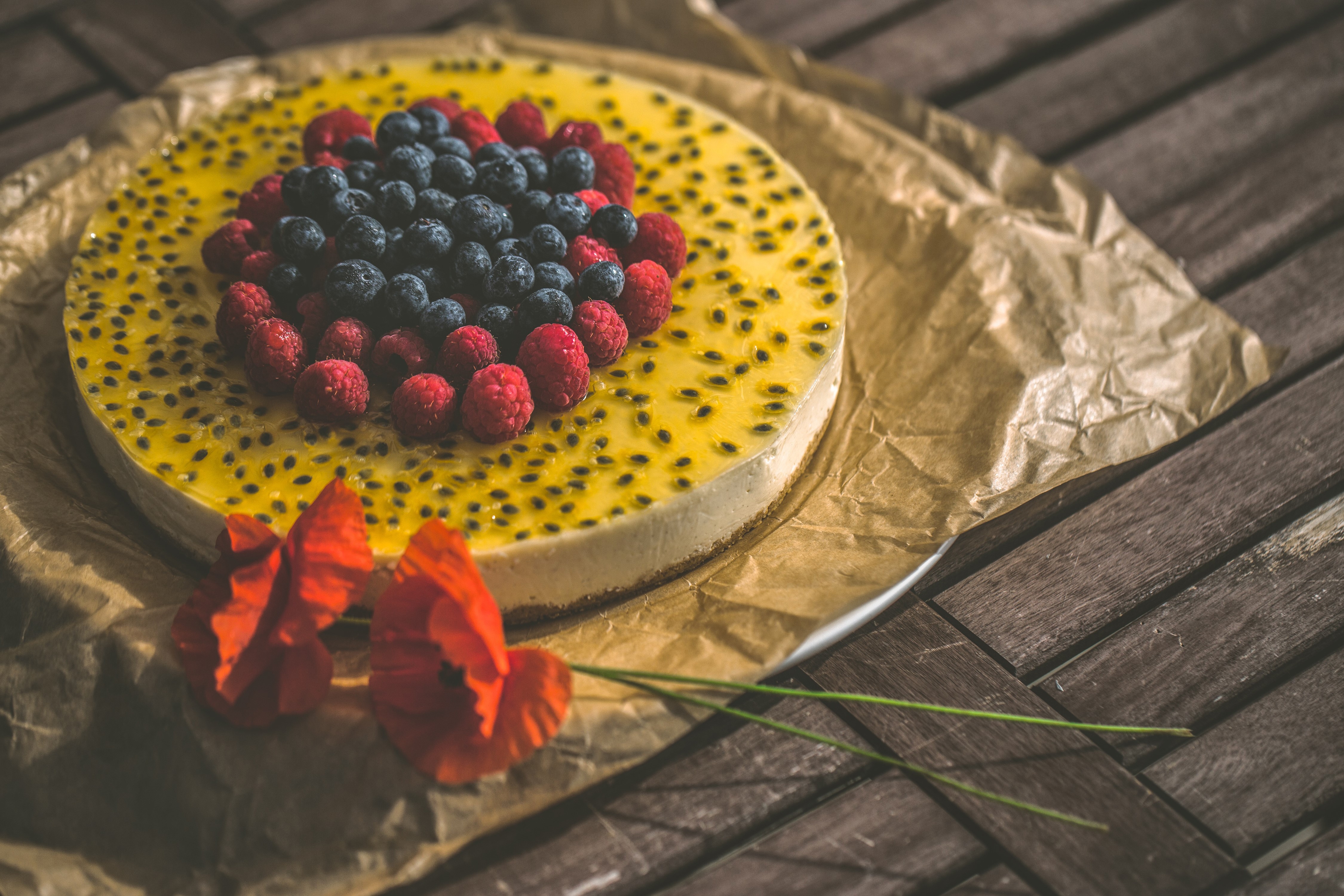 Cheesecake with berries and poppies on wooden planks HD Wallpaper