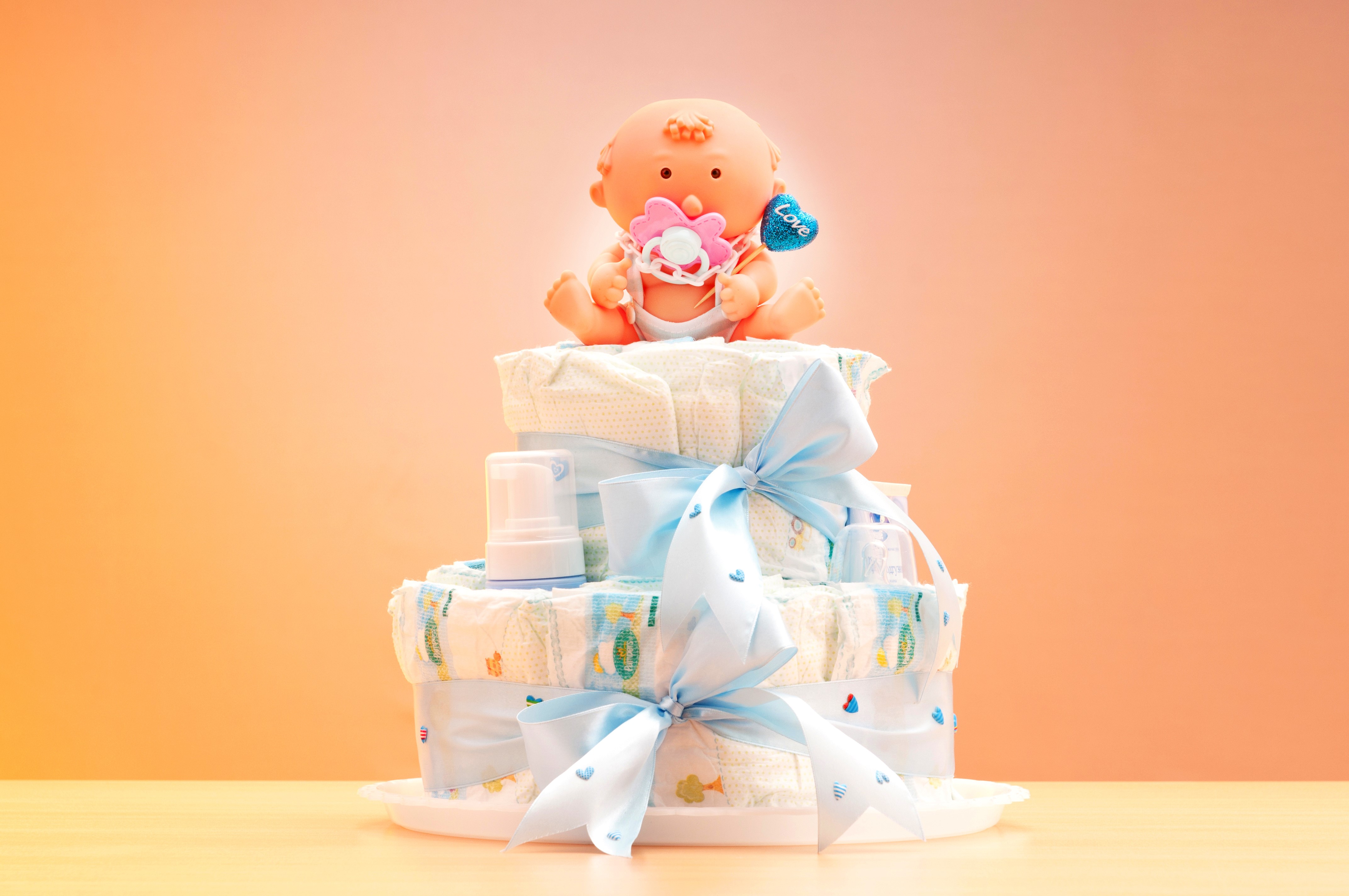 Diaper Cake with Baby Doll and Blue Bows HD Wallpaper