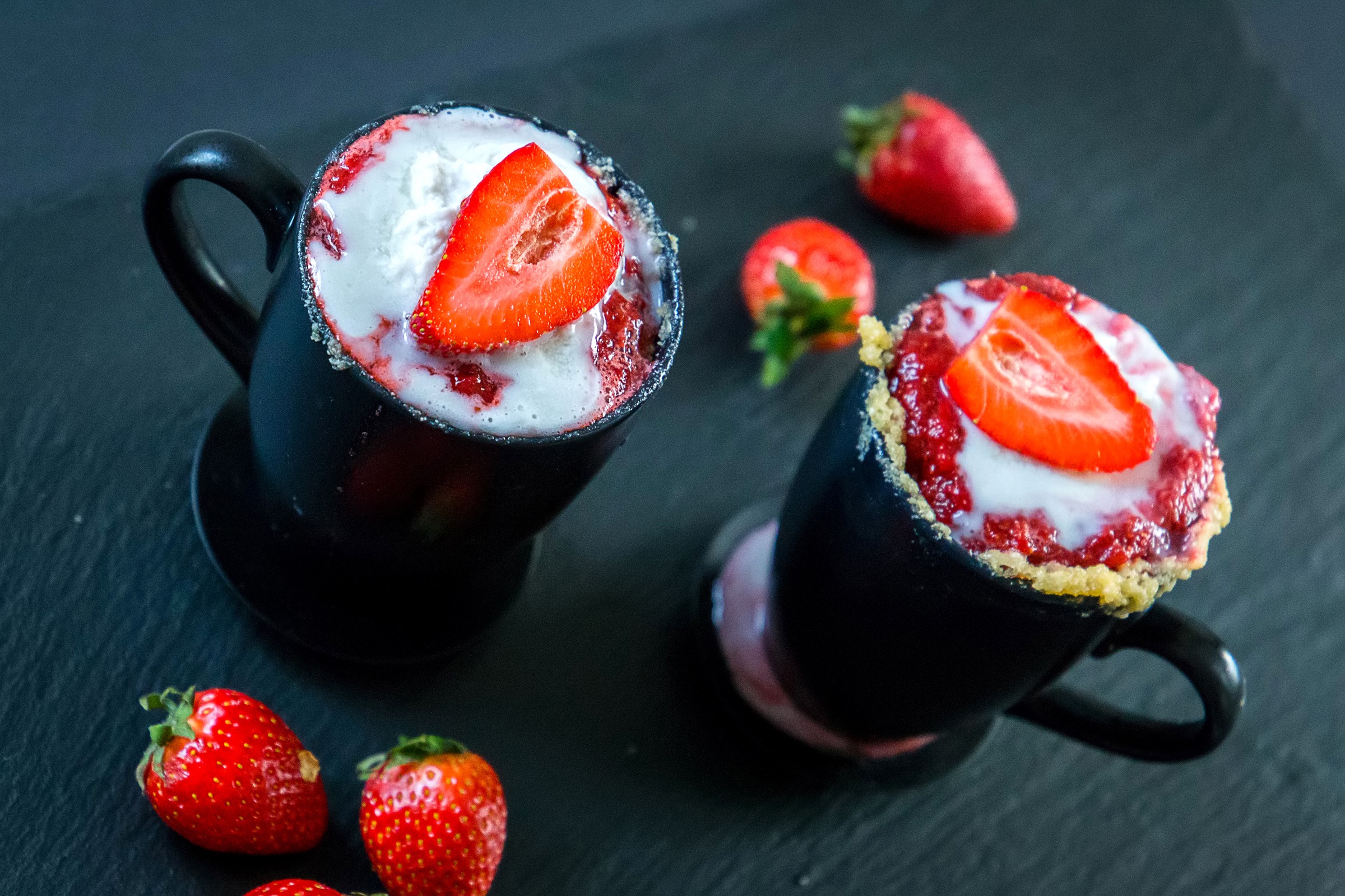 Two strawberry desserts in black cups with strawberries HD Wallpaper