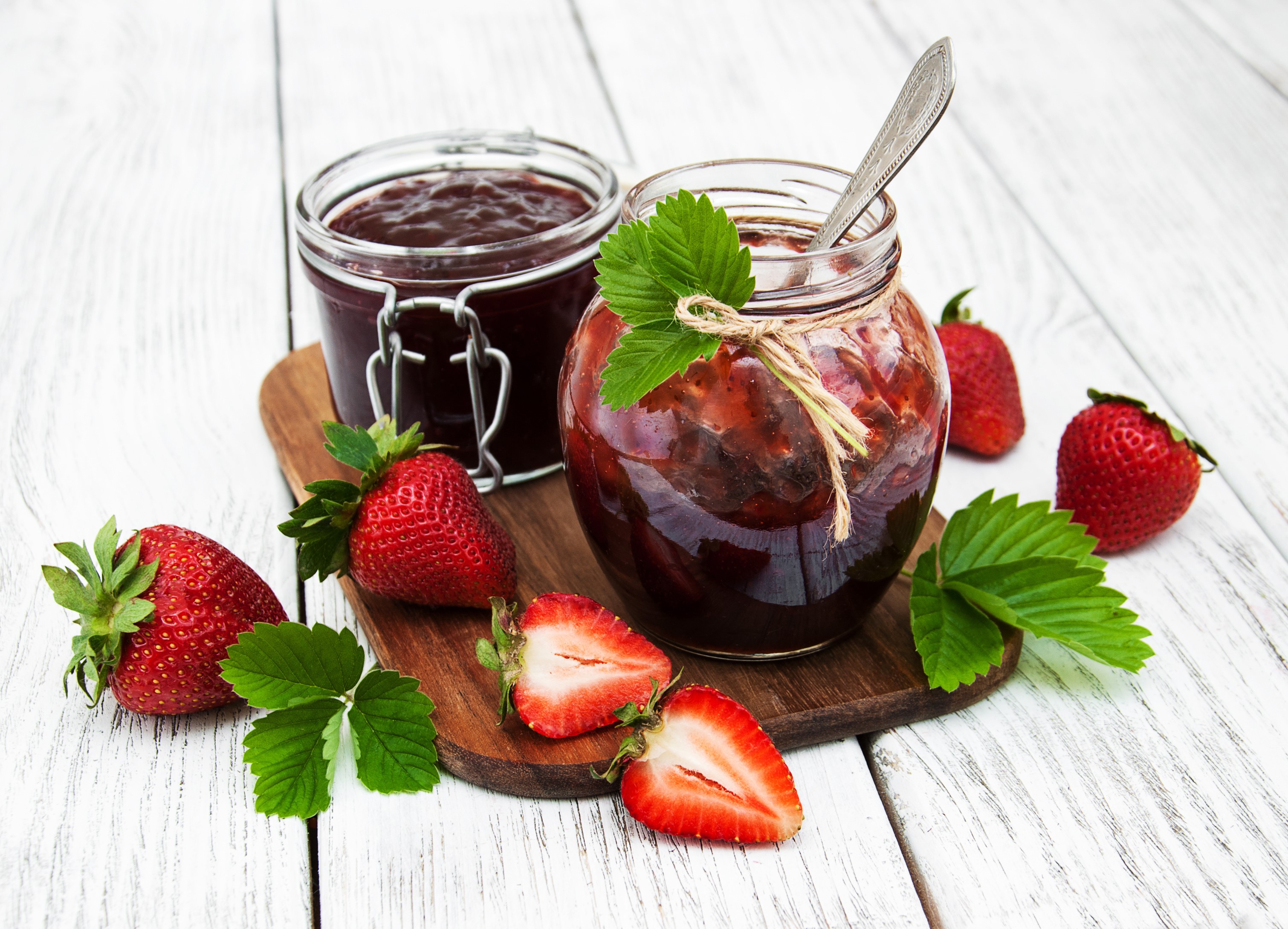 Strawberry jam in jars with fresh strawberries on wooden planks HD Wallpaper