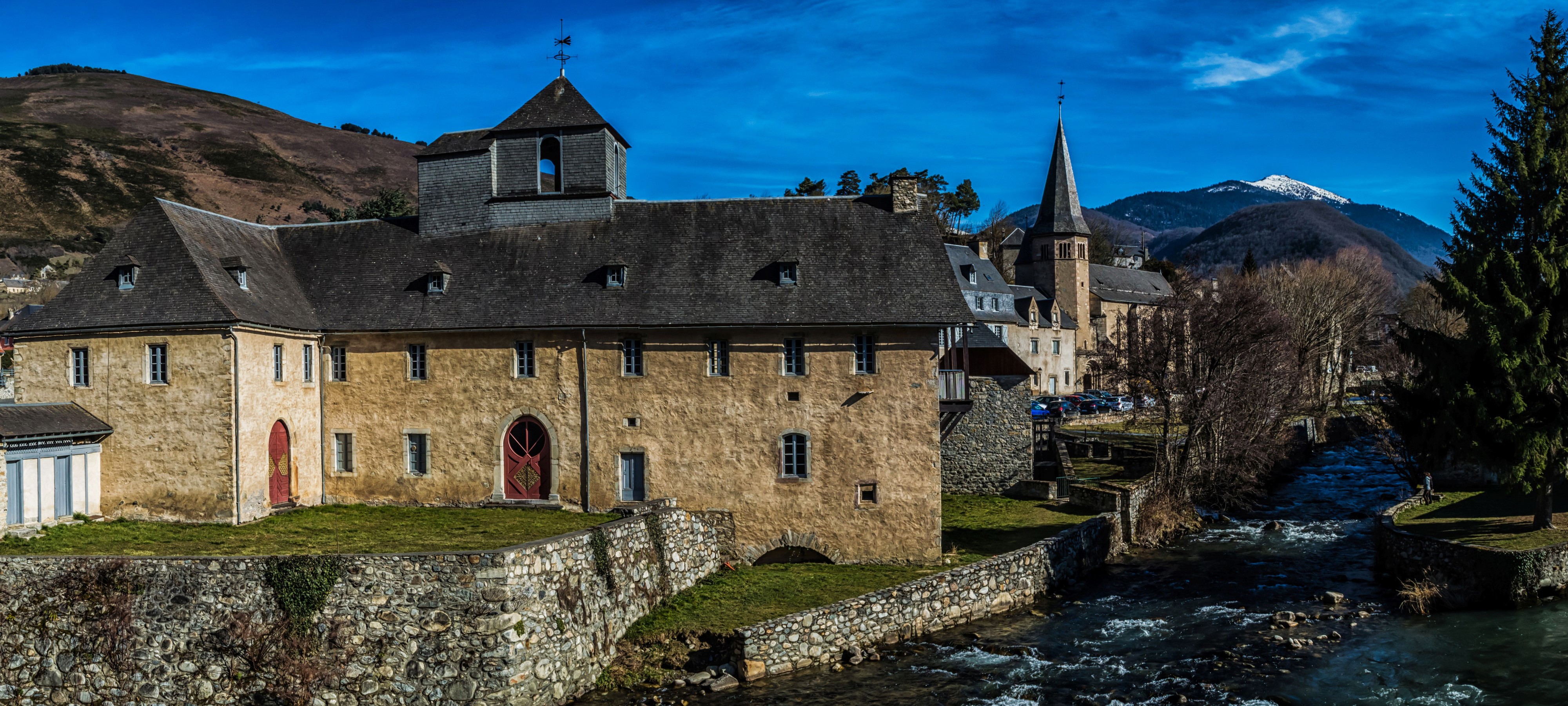 Arreau, France: Historic Buildings by a River HD Wallpaper