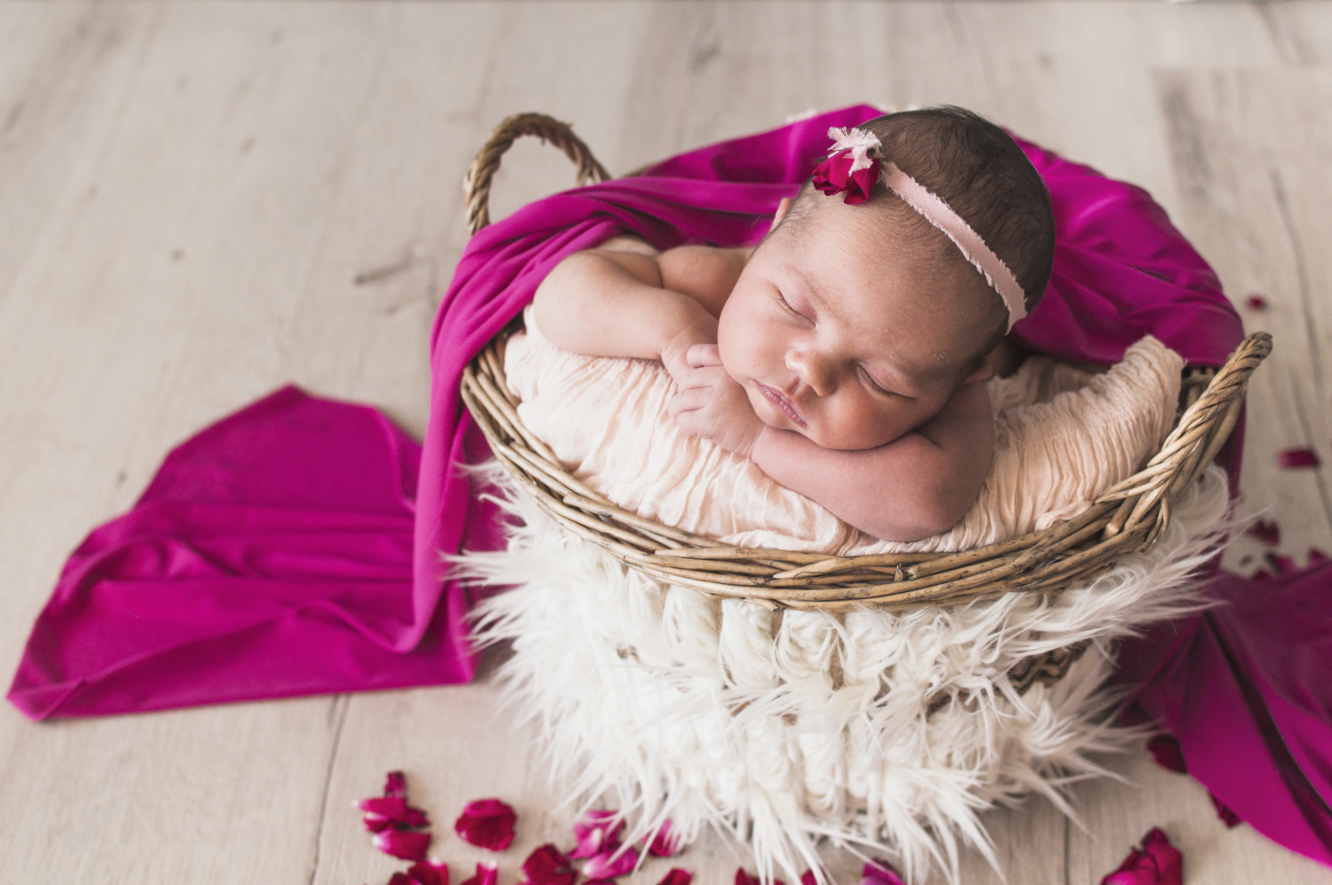 Newborn baby sleeping in a wicker basket HD Wallpaper