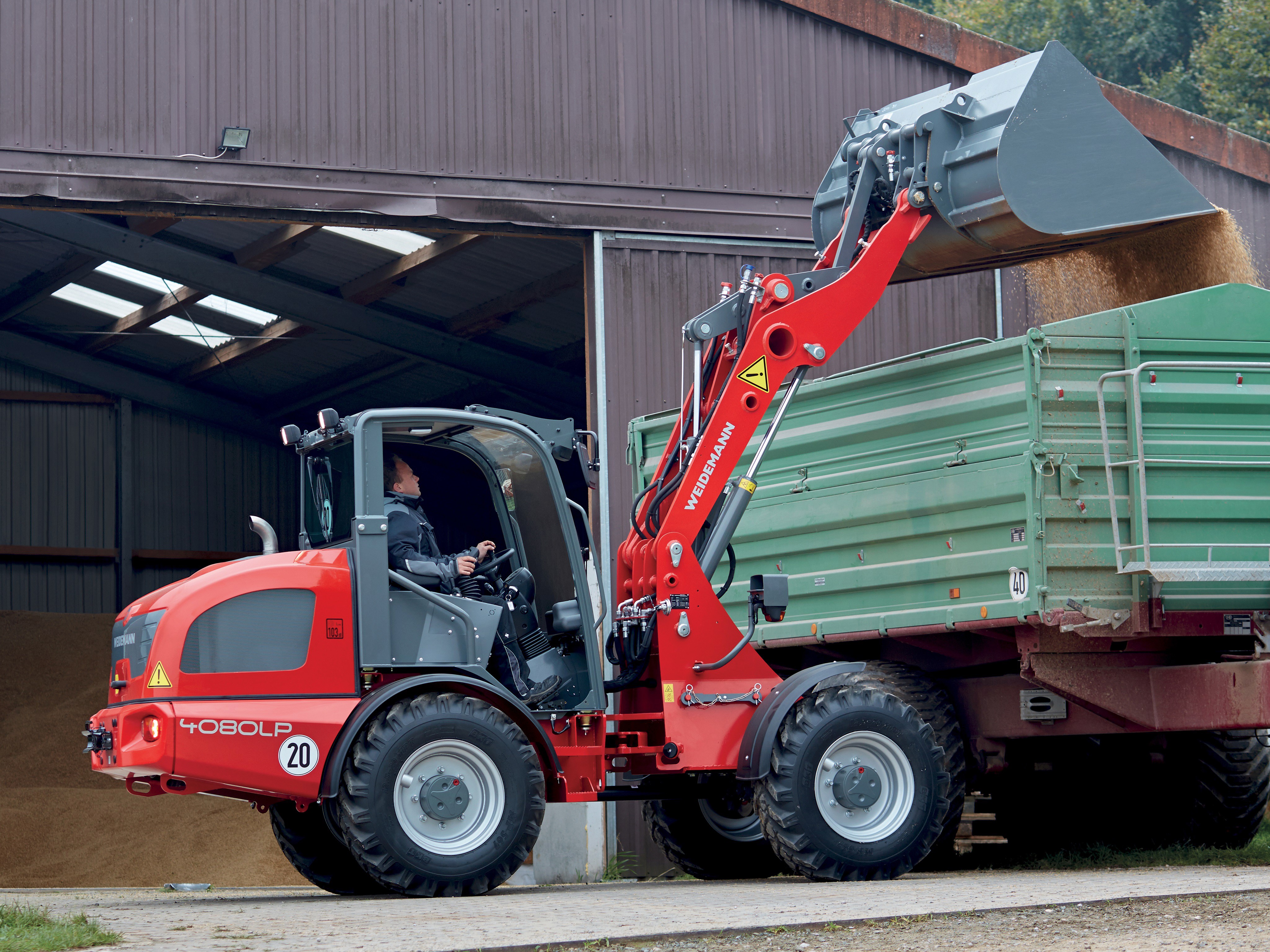 Weidemann 4080LP Loader dumping grain into a trailer HD Wallpaper