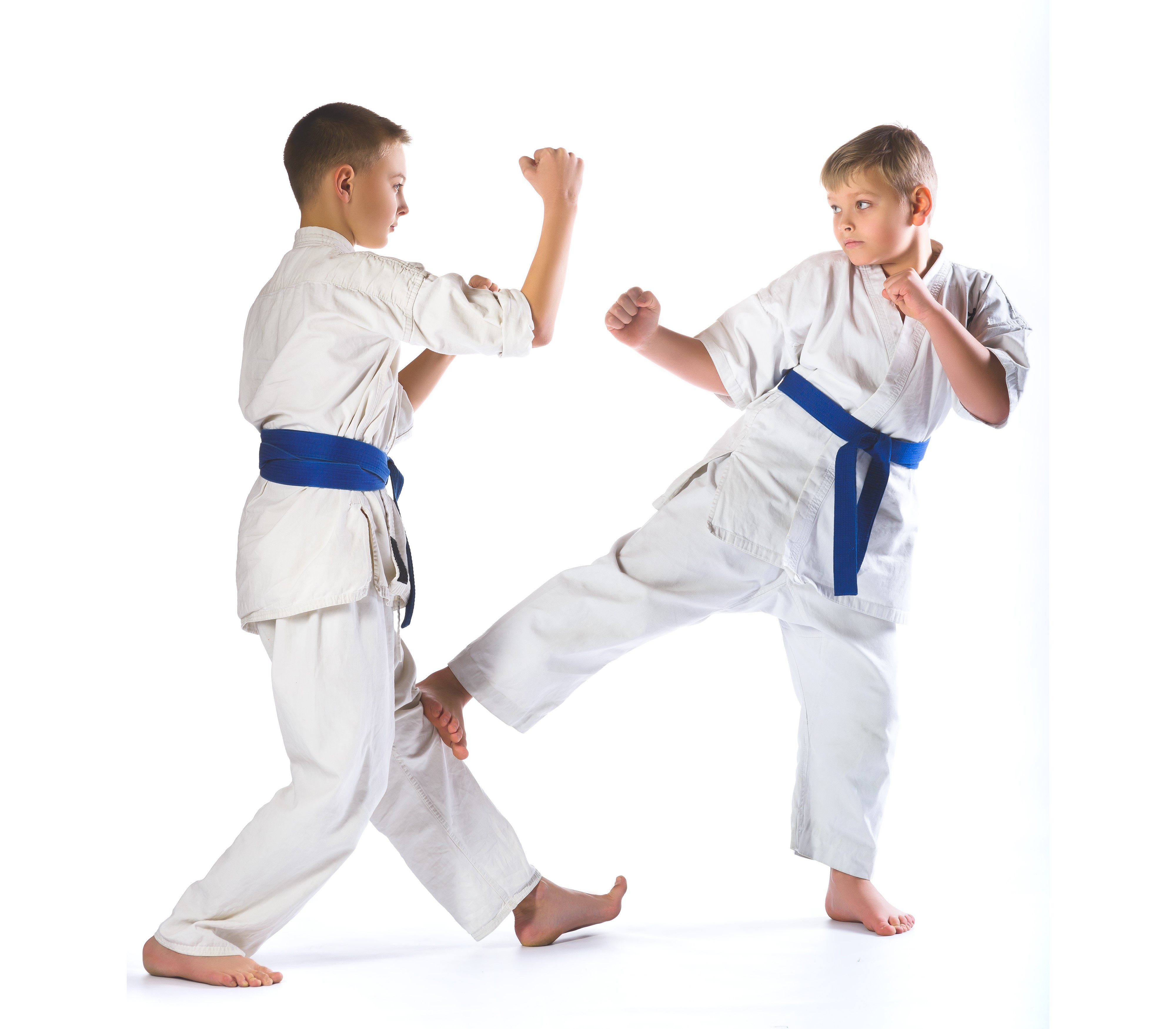 Two boys in karate uniforms practicing martial arts HD Wallpaper