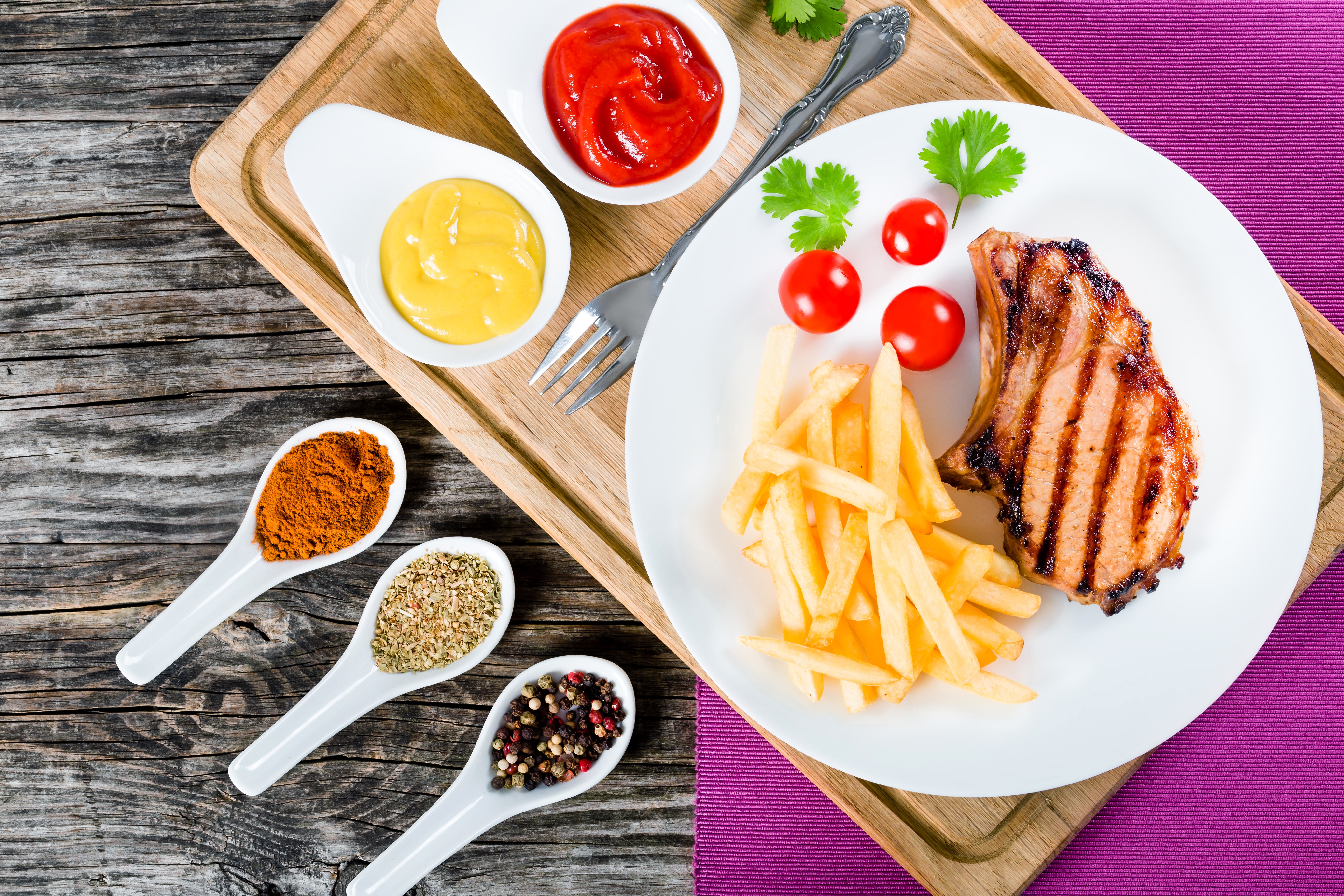 Pork chop with french fries, tomatoes, and spices HD Wallpaper