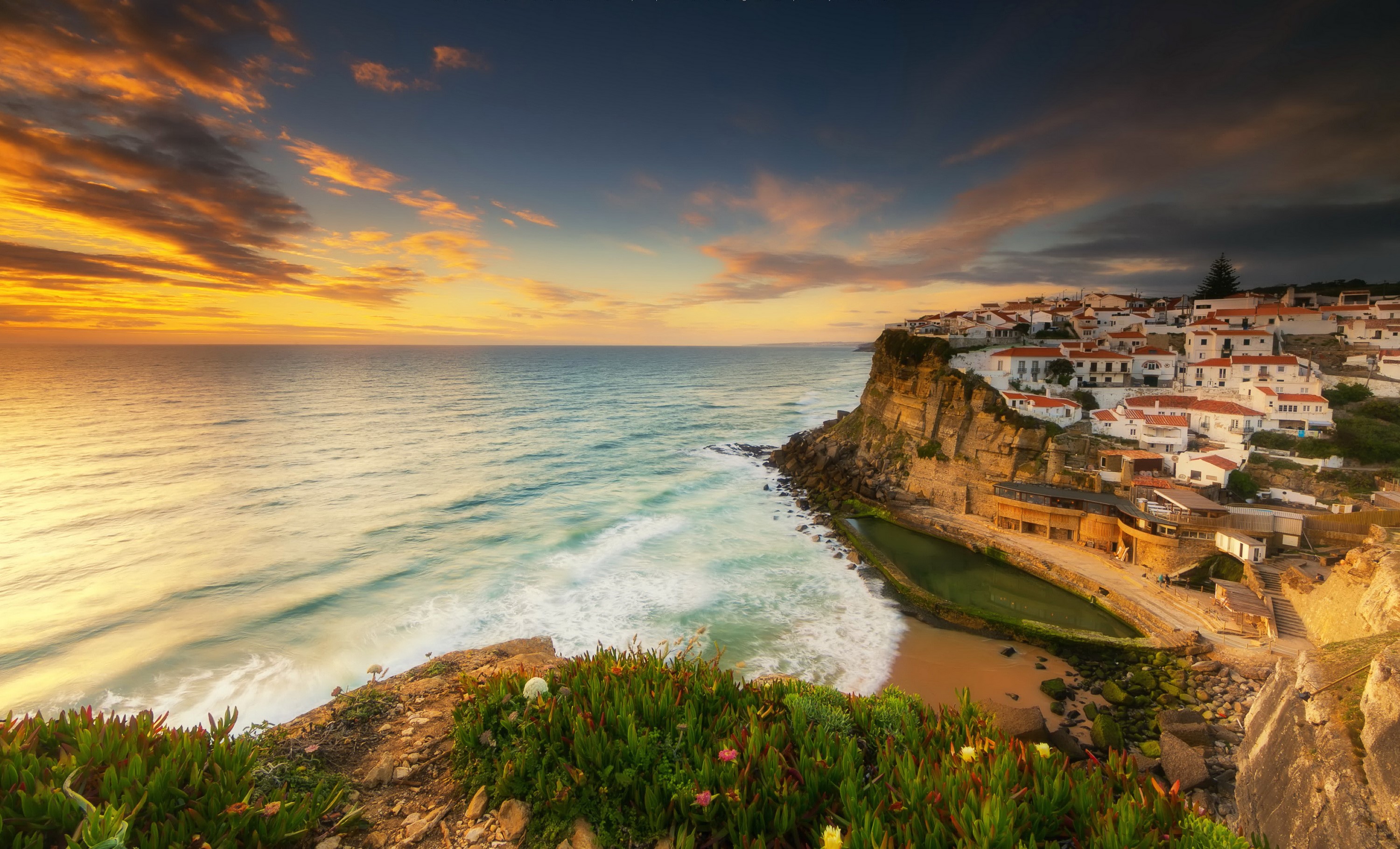 Coastal village on a cliffside in Portugal at sunset HD Wallpaper