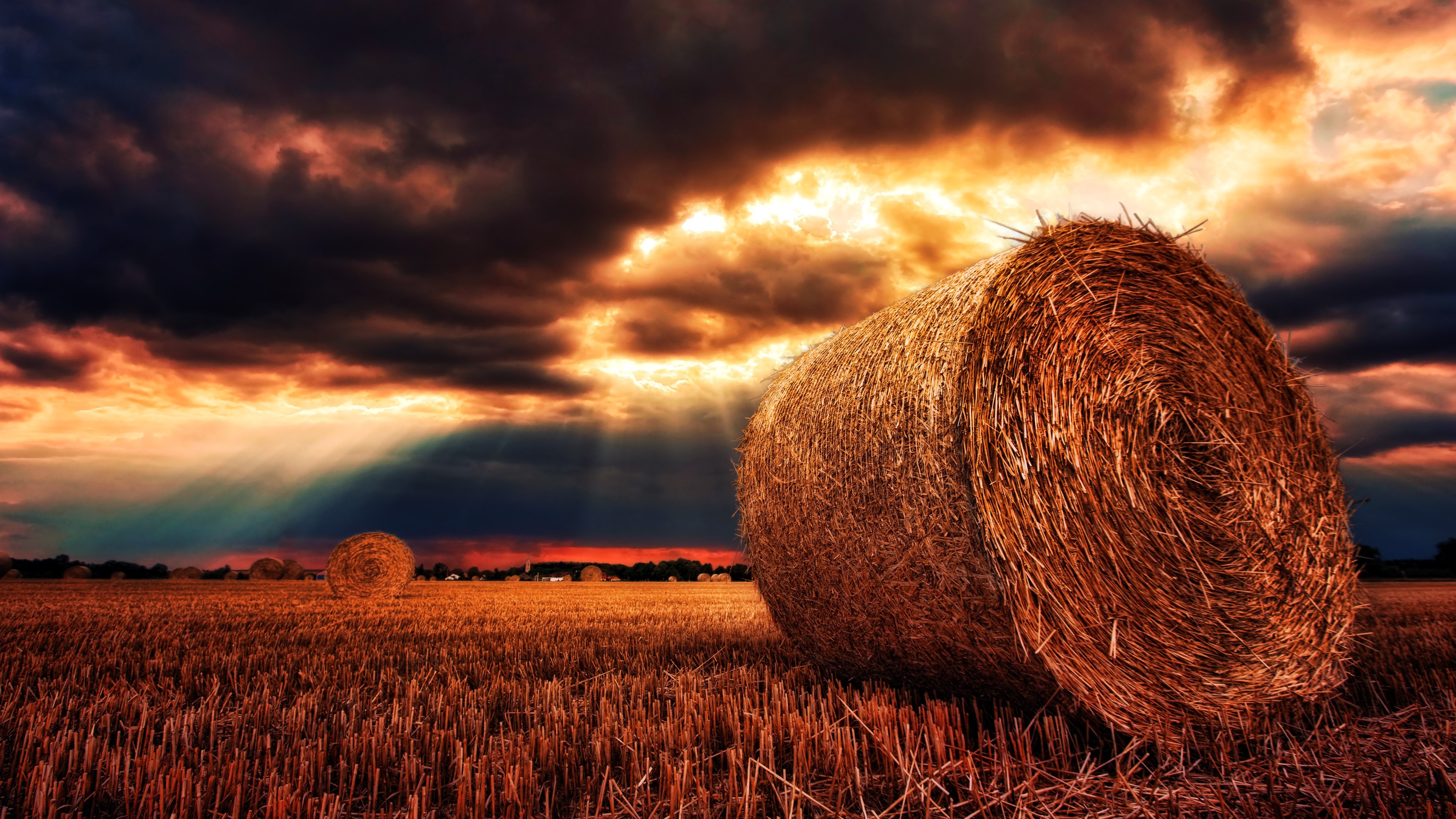 Hay bales in a field at sunset HD Wallpaper