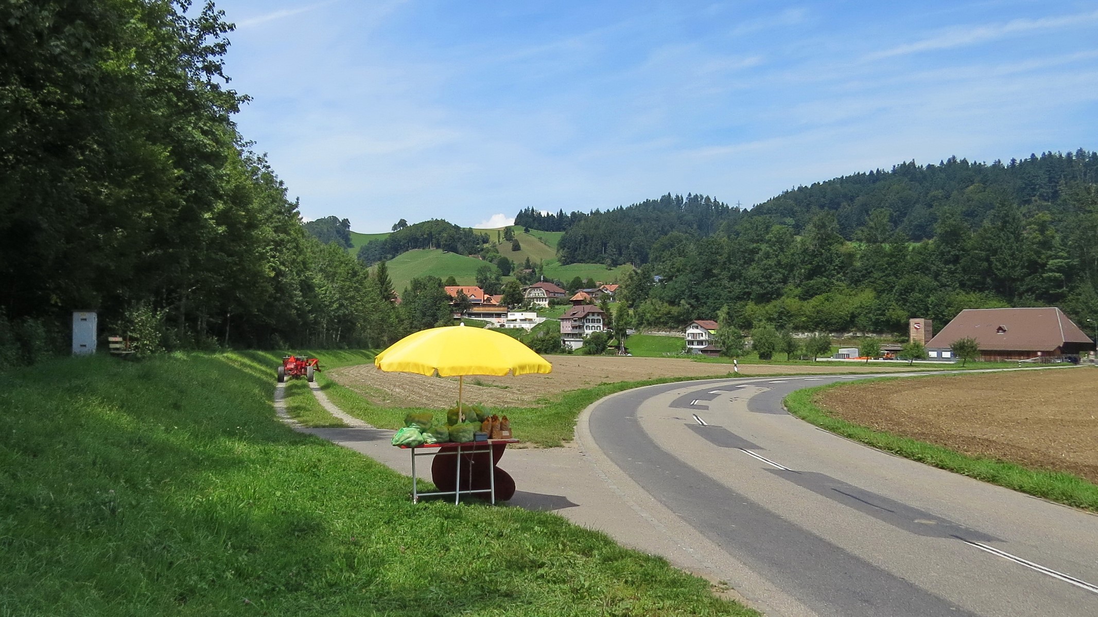Roadside fruit stand with a tractor in Lutzelfluh, Switzerland HD Wallpaper