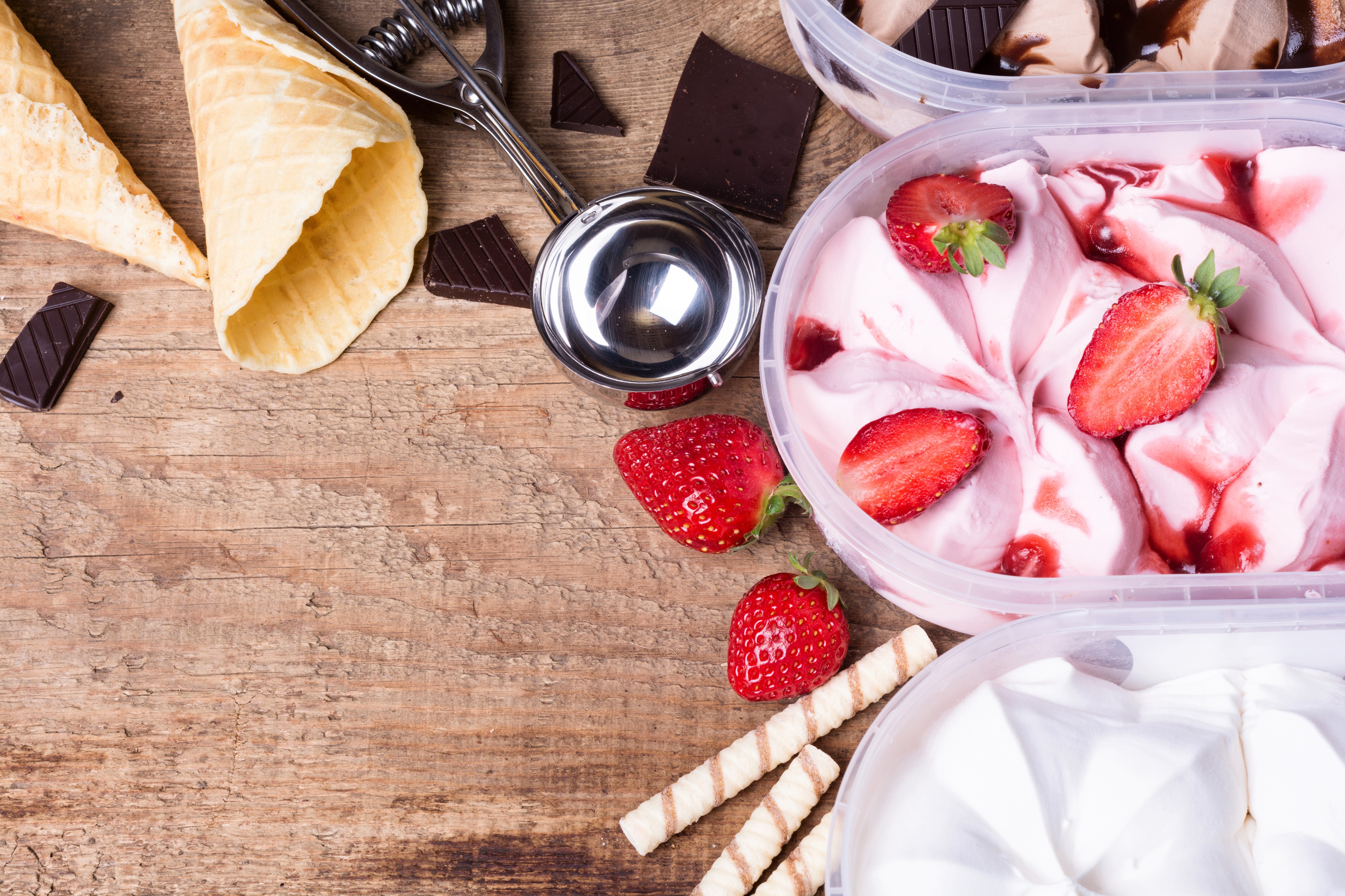 Ice cream cones, chocolate, strawberries, and ice cream tubs HD Wallpaper