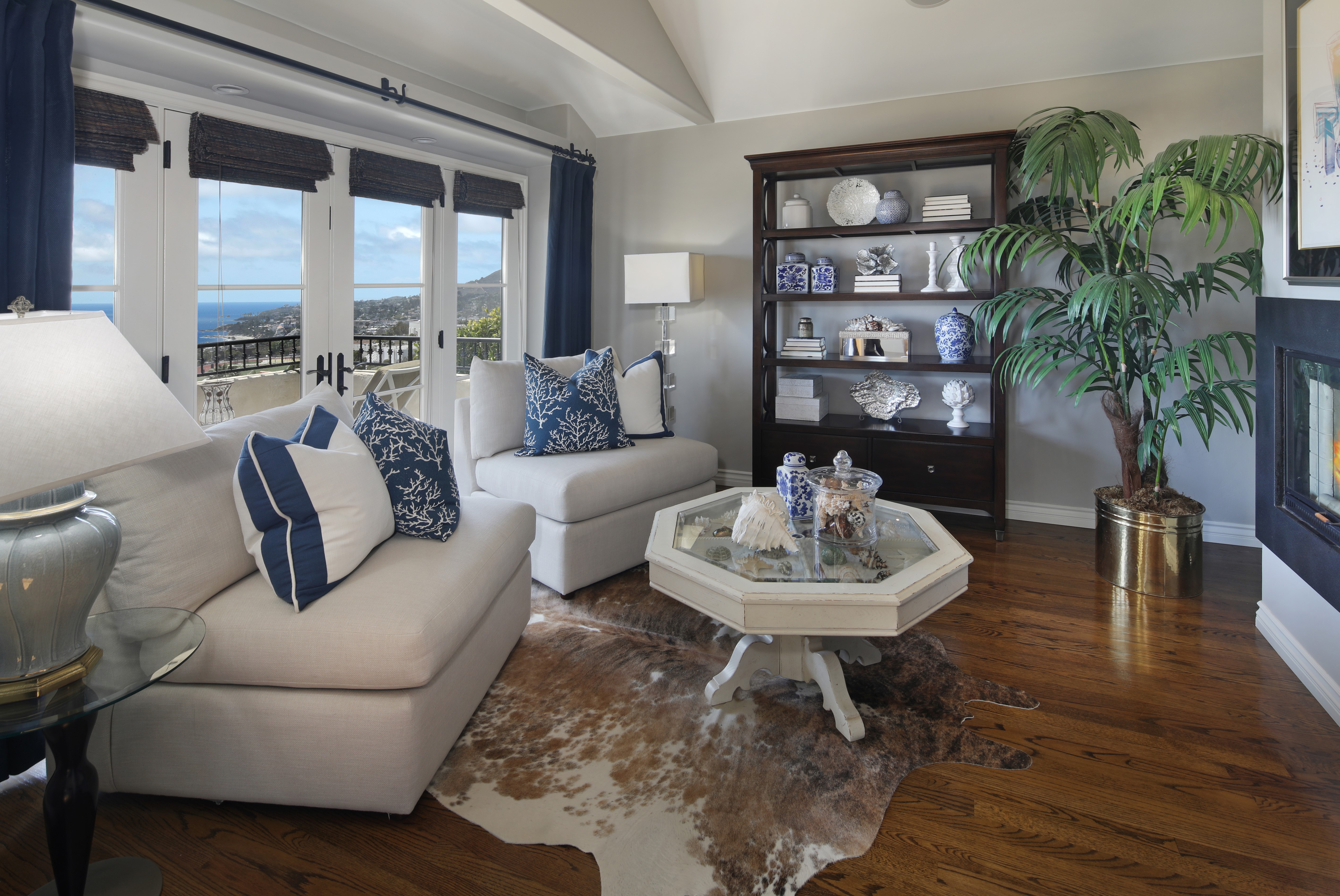 Living room with sofas, coffee table, and bookshelf HD Wallpaper