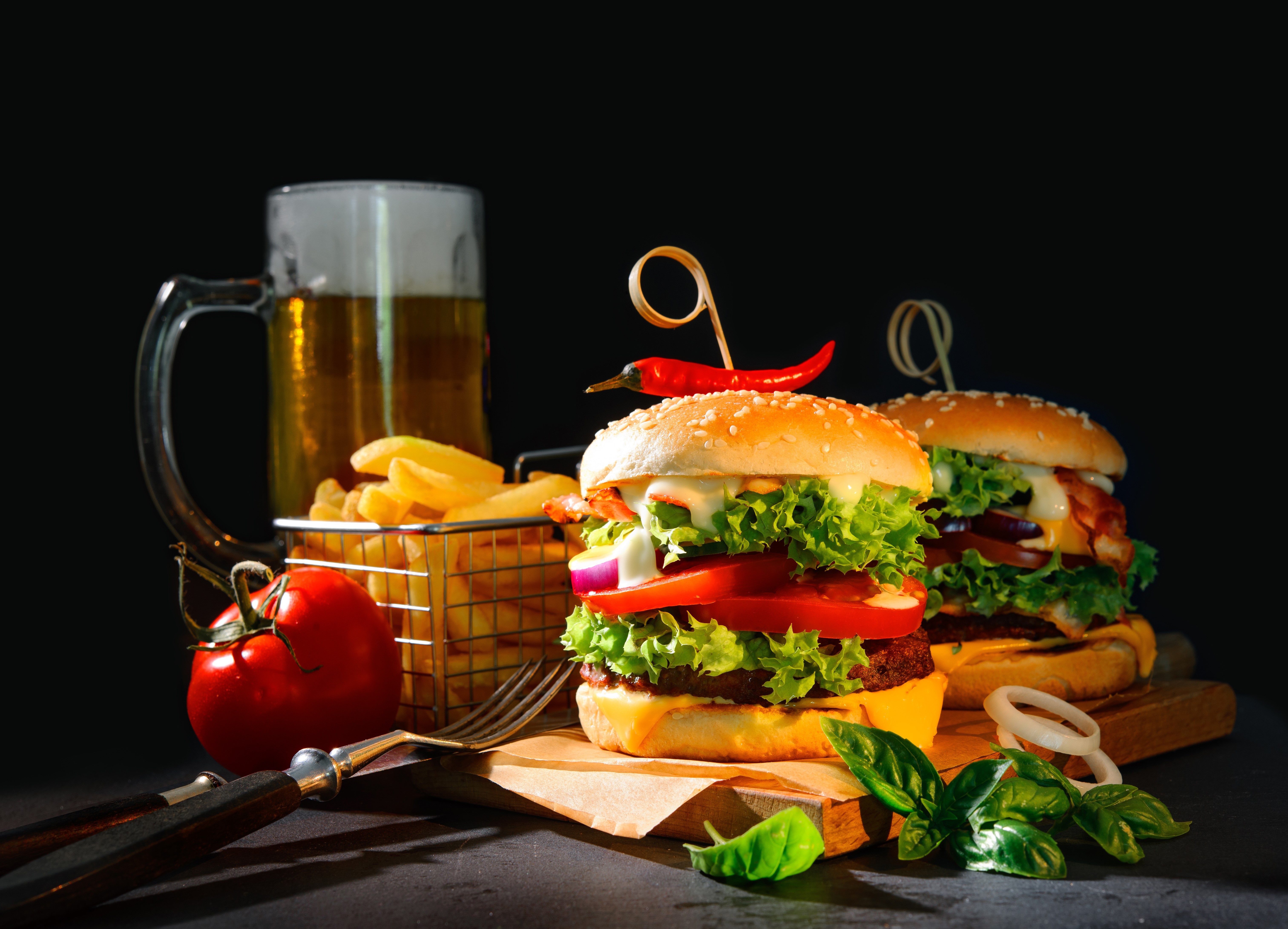 Hamburgers with fries and beer on a cutting board HD Wallpaper
