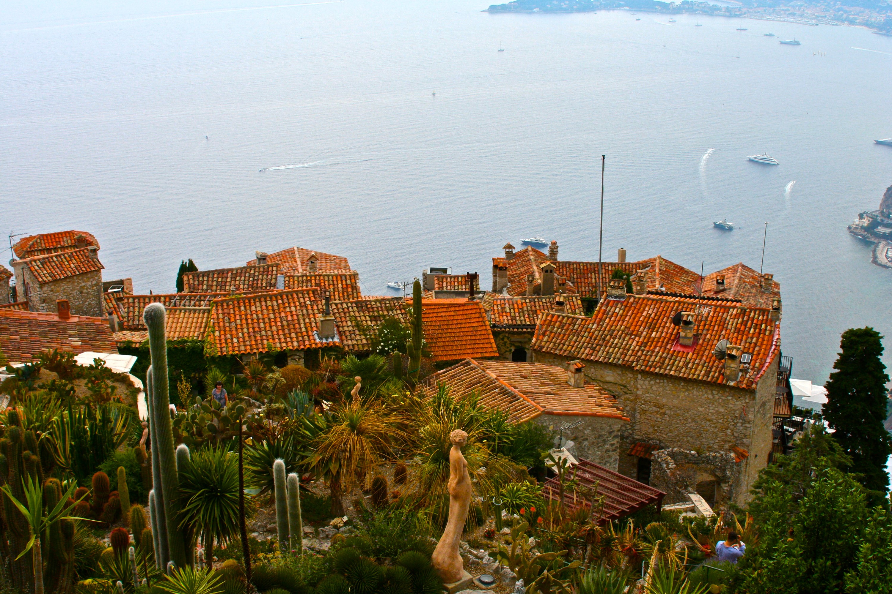 Village with terracotta roofs and cactus garden overlooking the sea in Eze, France HD Wallpaper