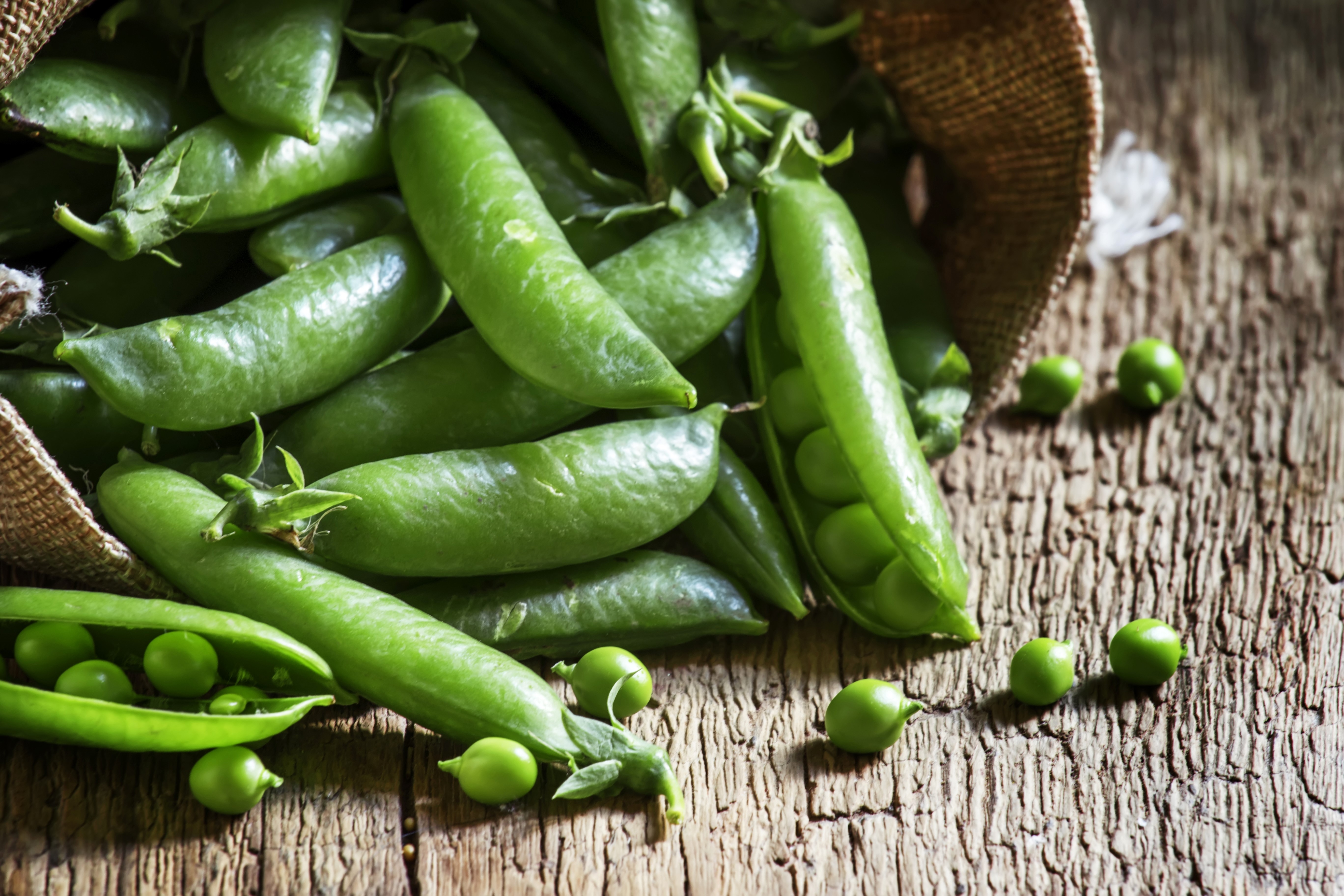 Green peas in a basket on wood HD Wallpaper