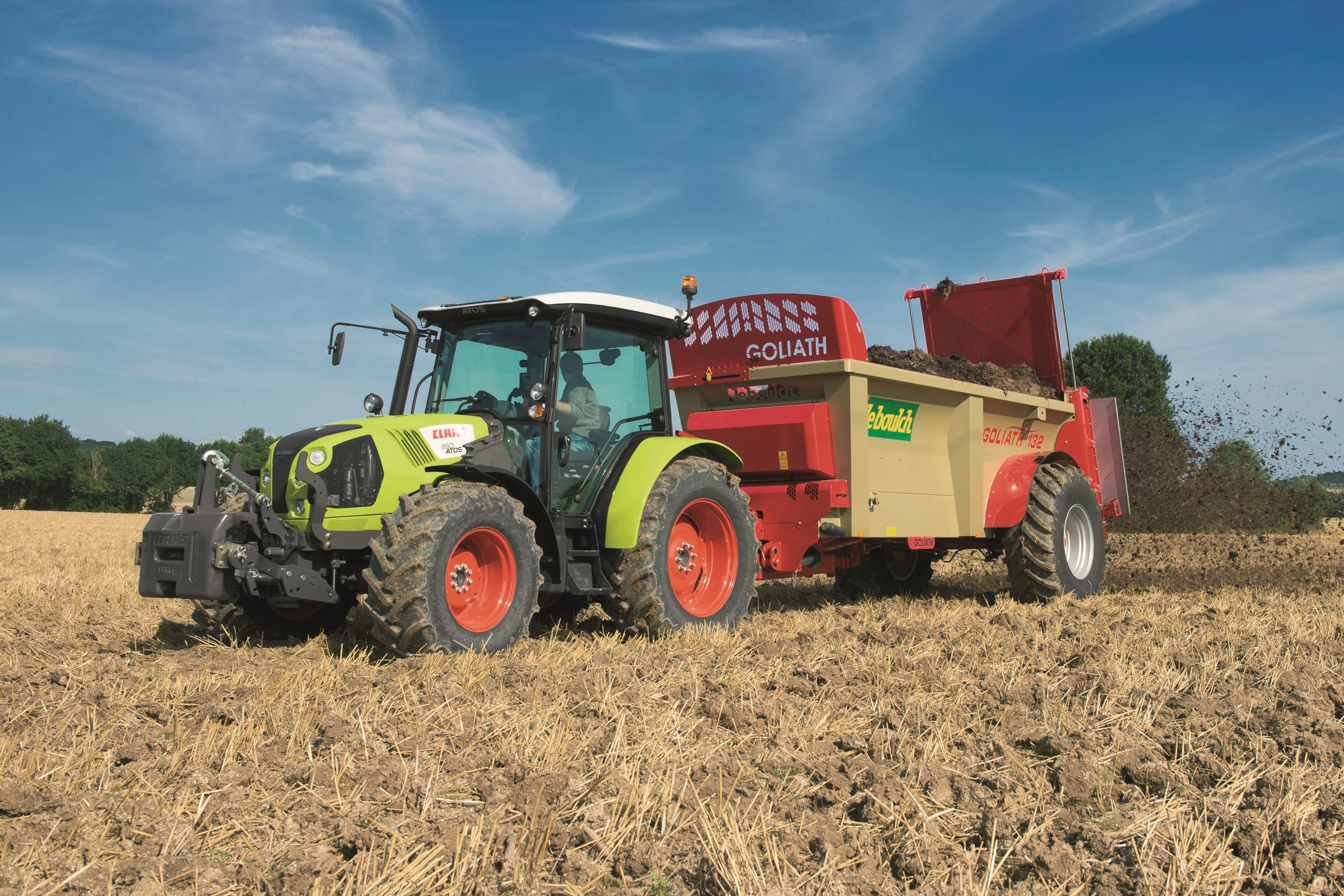 Claas Atos 350 tractor spreading fertilizer in a field HD Wallpaper