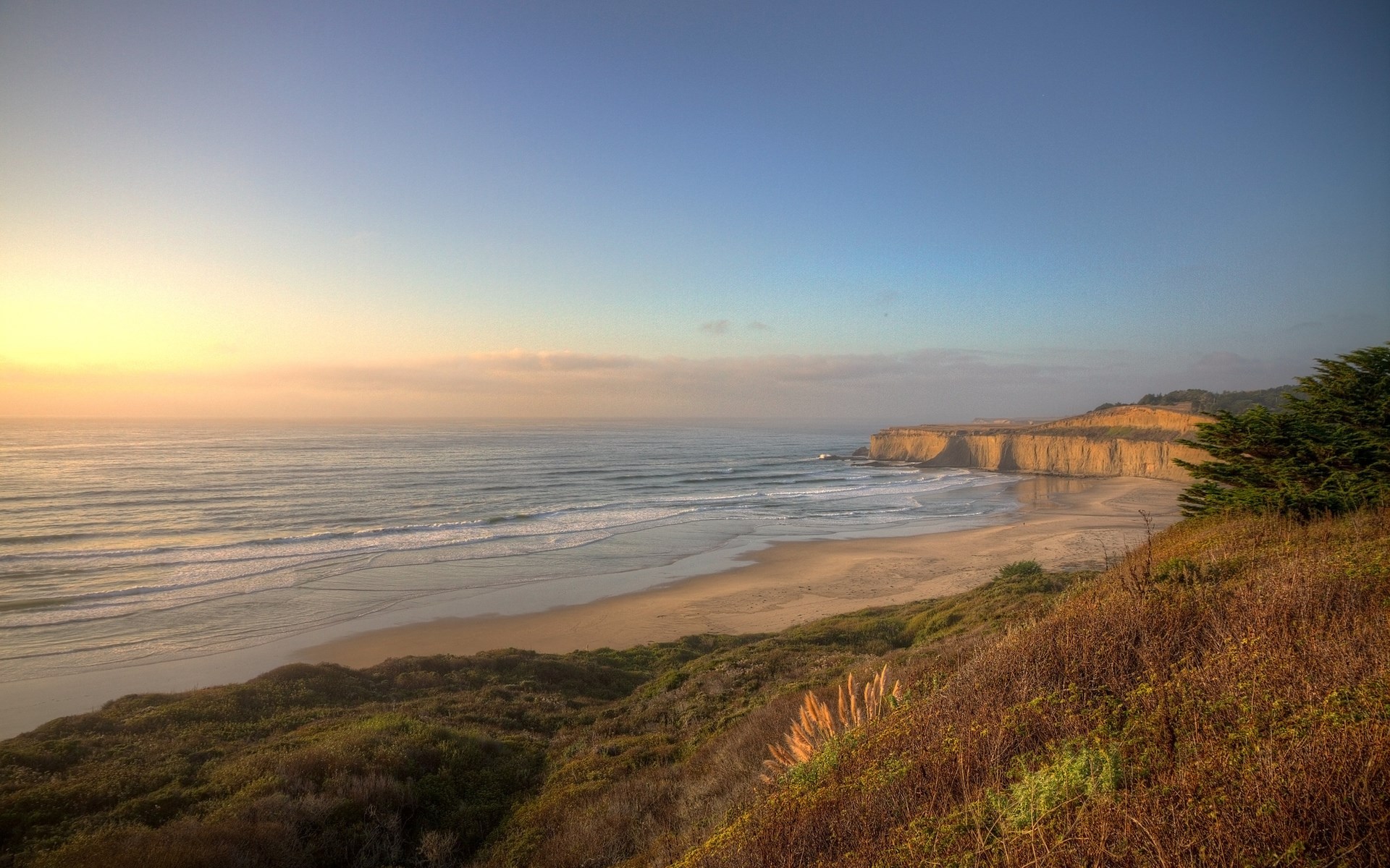 Coastal cliffs and beach at sunset HD Wallpaper