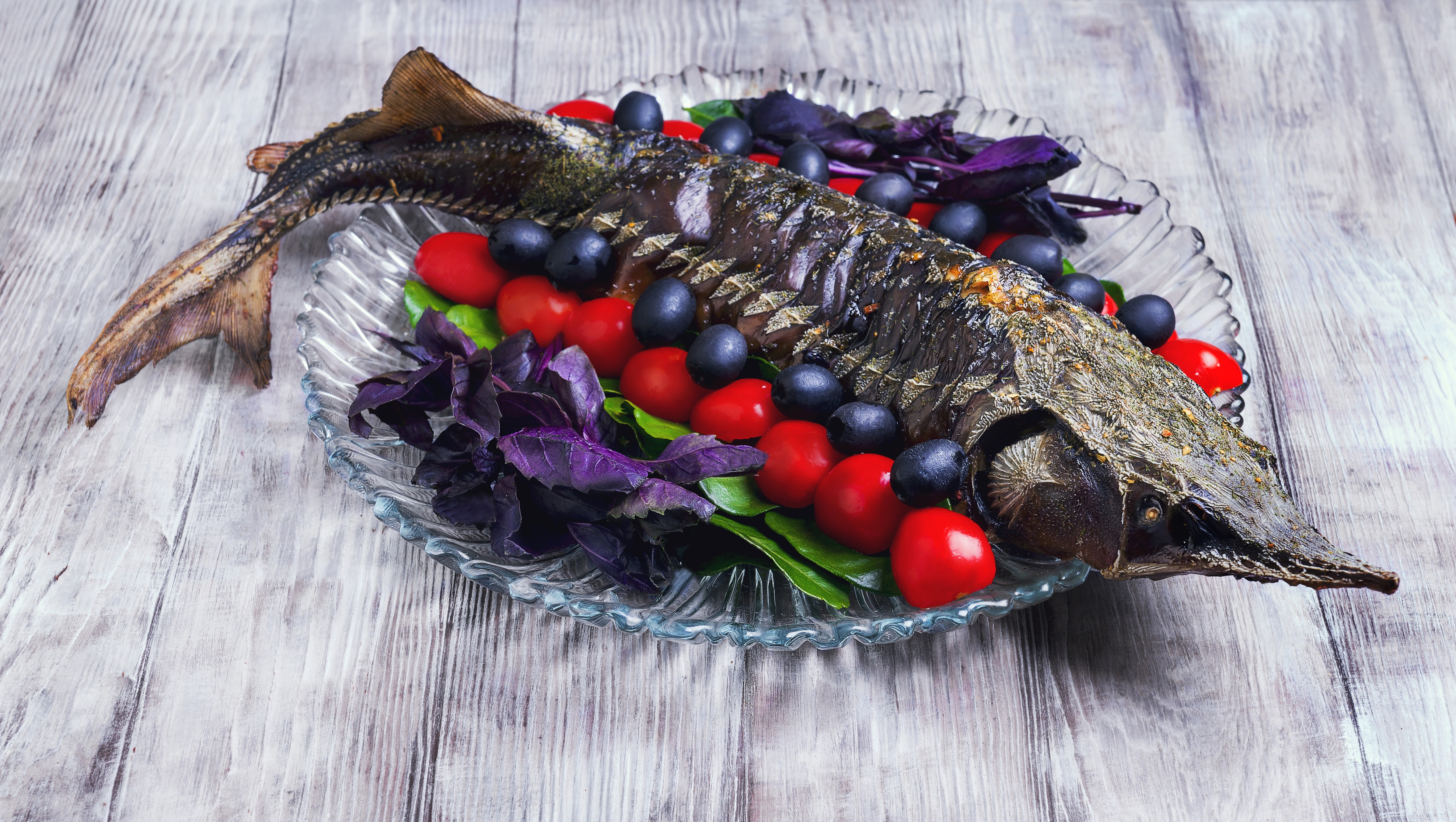 Whole cooked sturgeon with tomatoes, olives, and basil HD Wallpaper