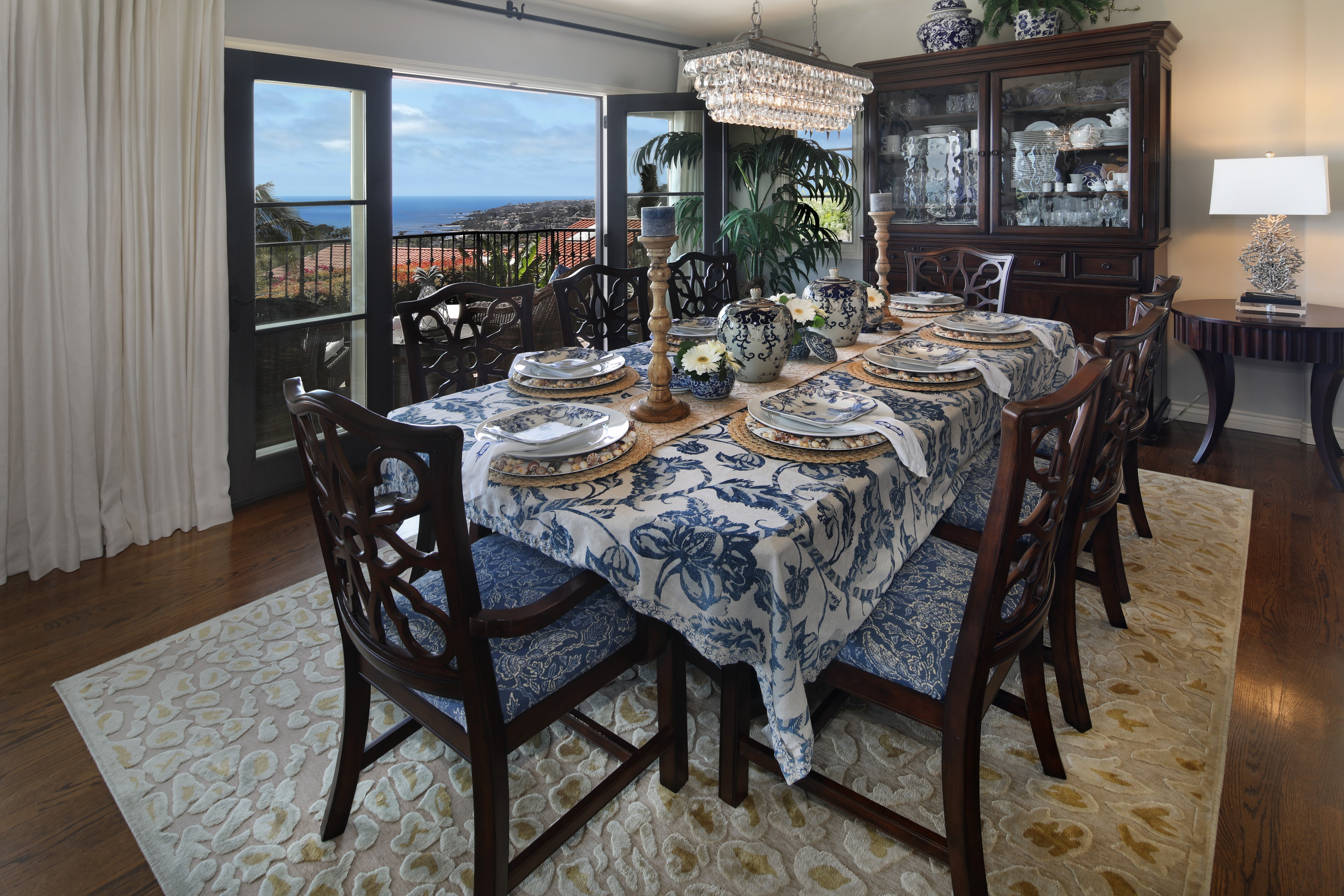 Dining room with ocean view and chandelier HD Wallpaper
