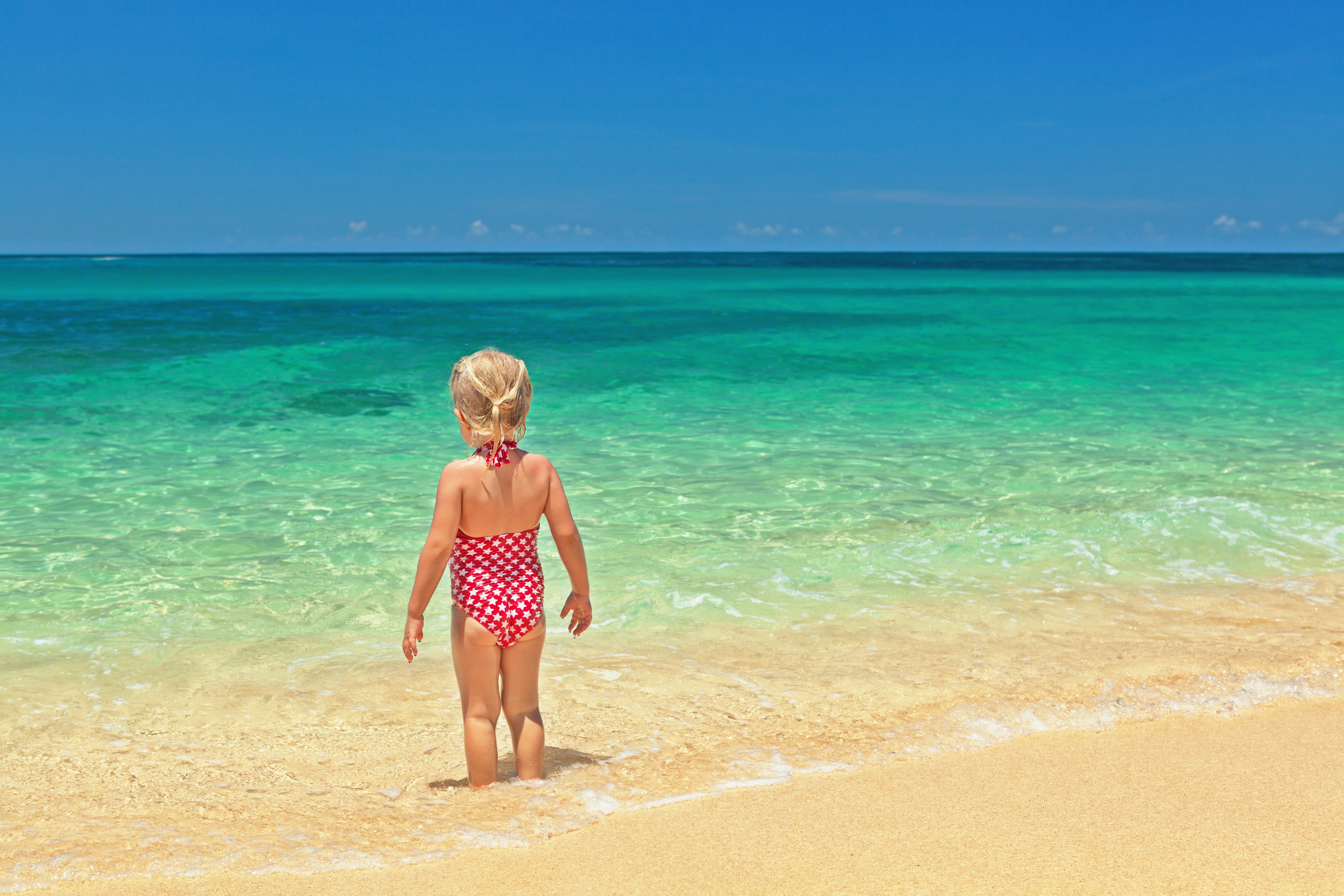 Little girl in swimsuit at the beach HD Wallpaper