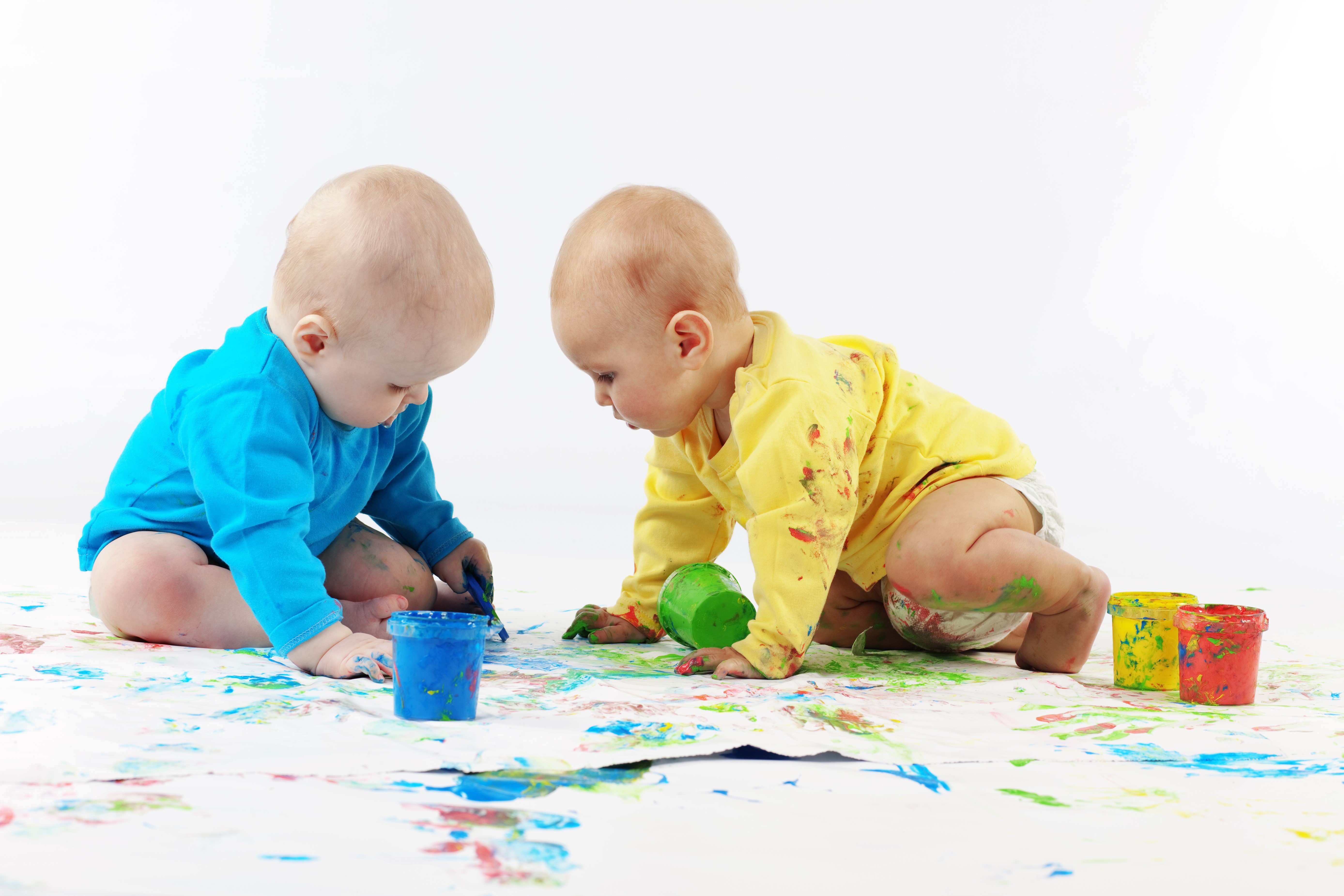 Two babies painting with colorful paints HD Wallpaper