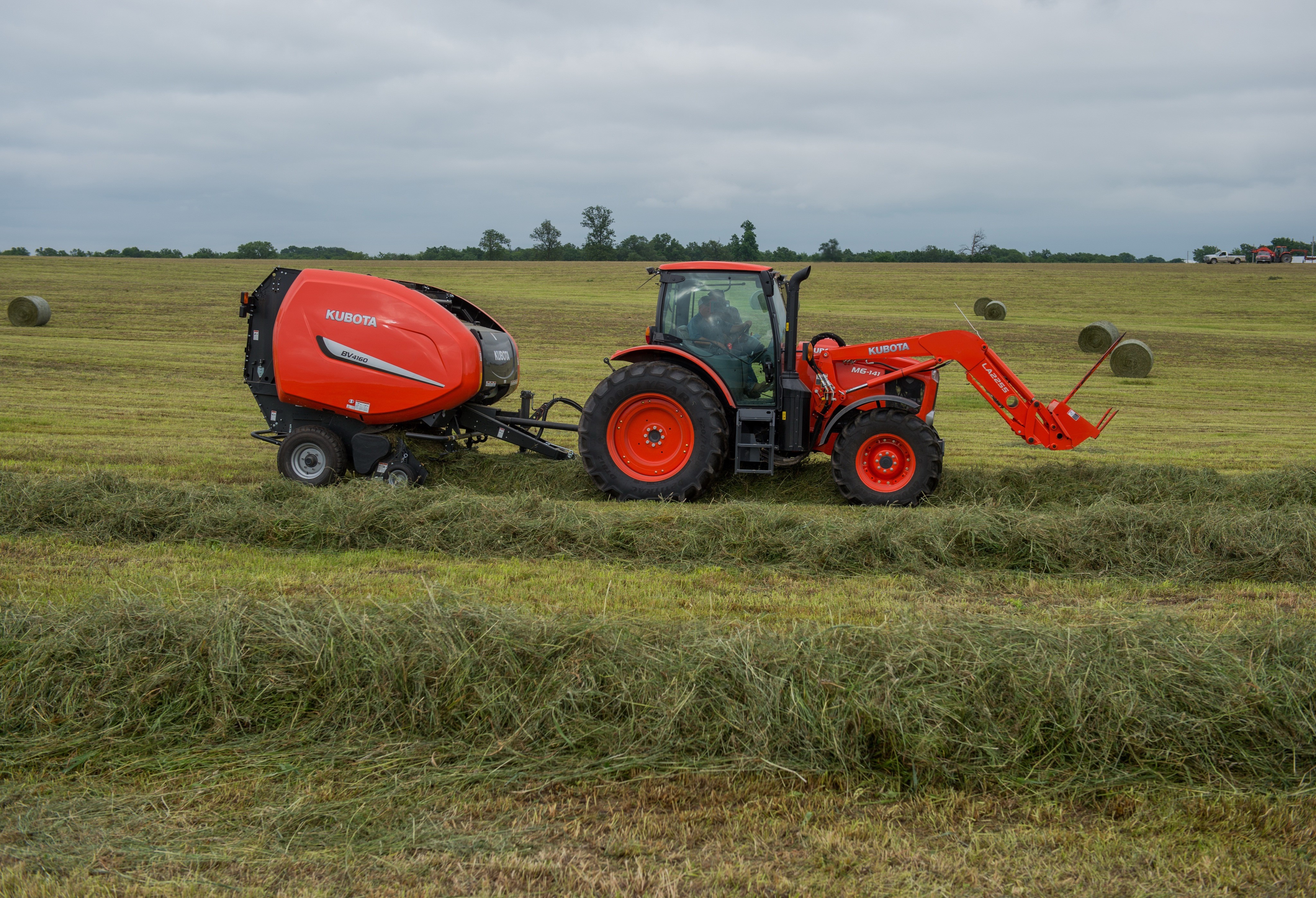 Kubota Tractor and Baler in a Field HD Wallpaper
