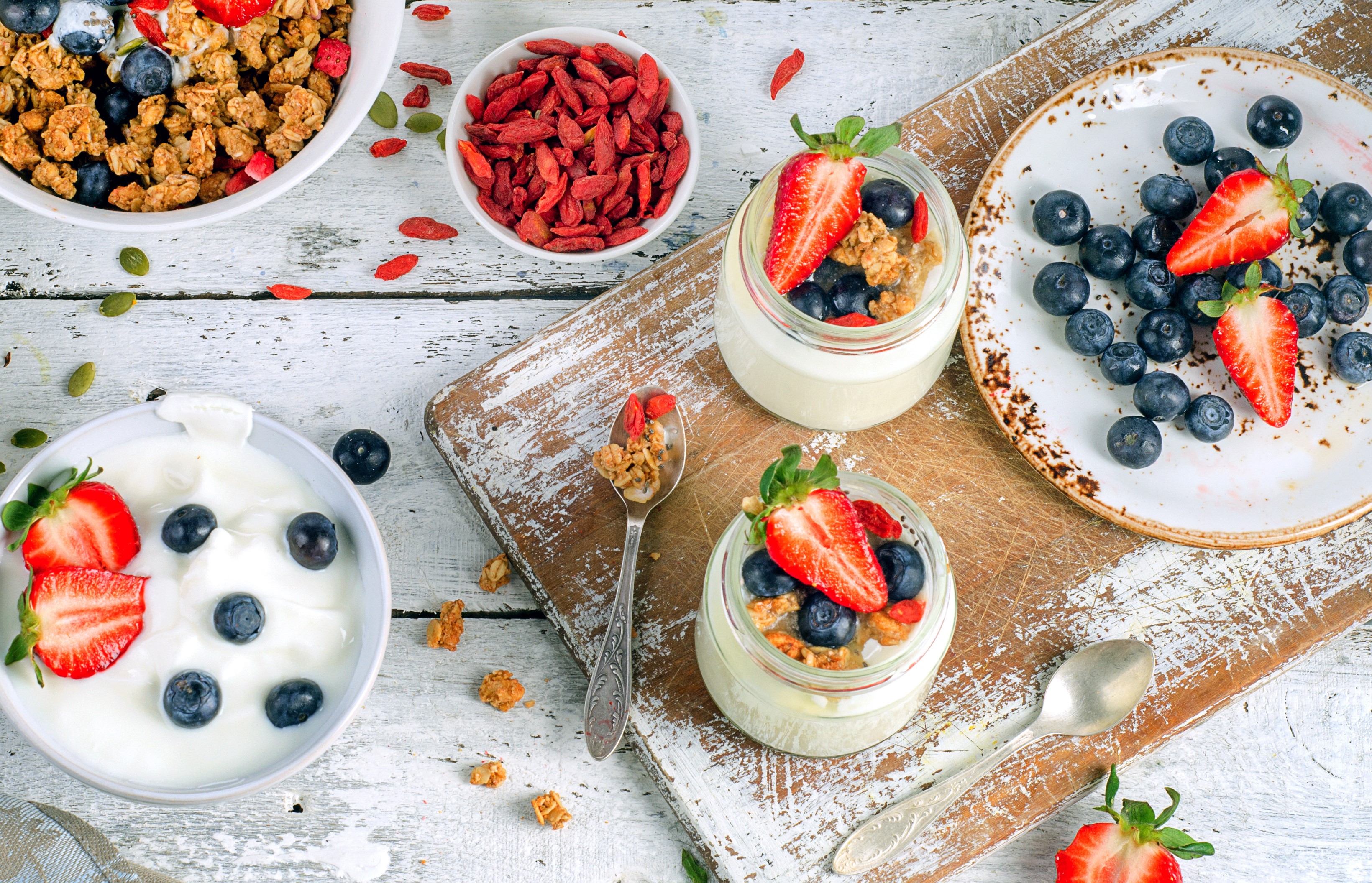 Yogurt parfaits with berries and granola on wooden board HD Wallpaper