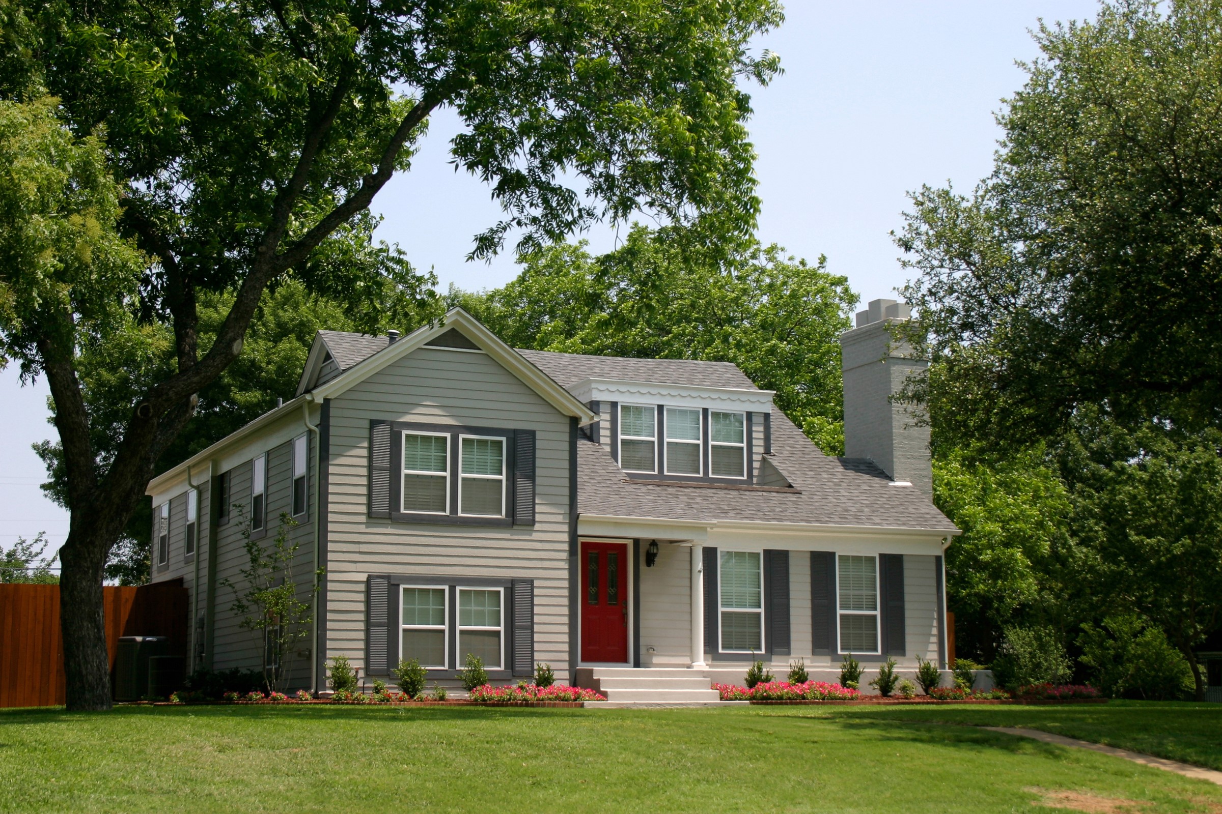 Two-story house with red door and gray shutters HD Wallpaper