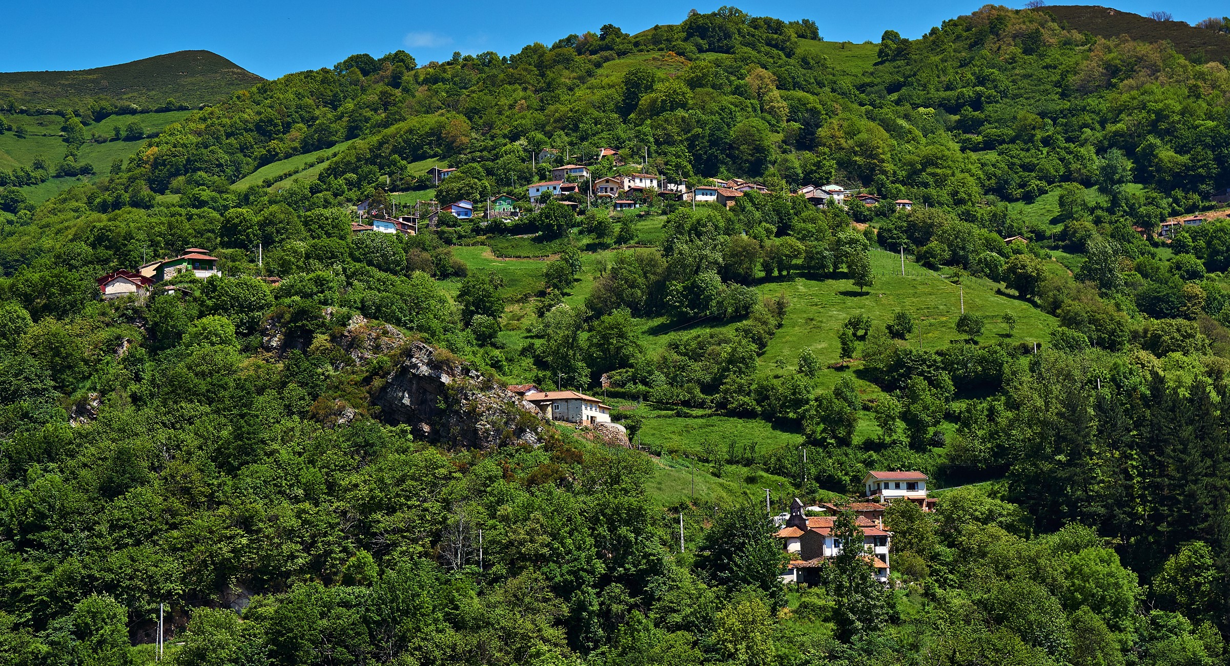 Houses nestled in green hills of Proacina, Asturias, Spain HD Wallpaper