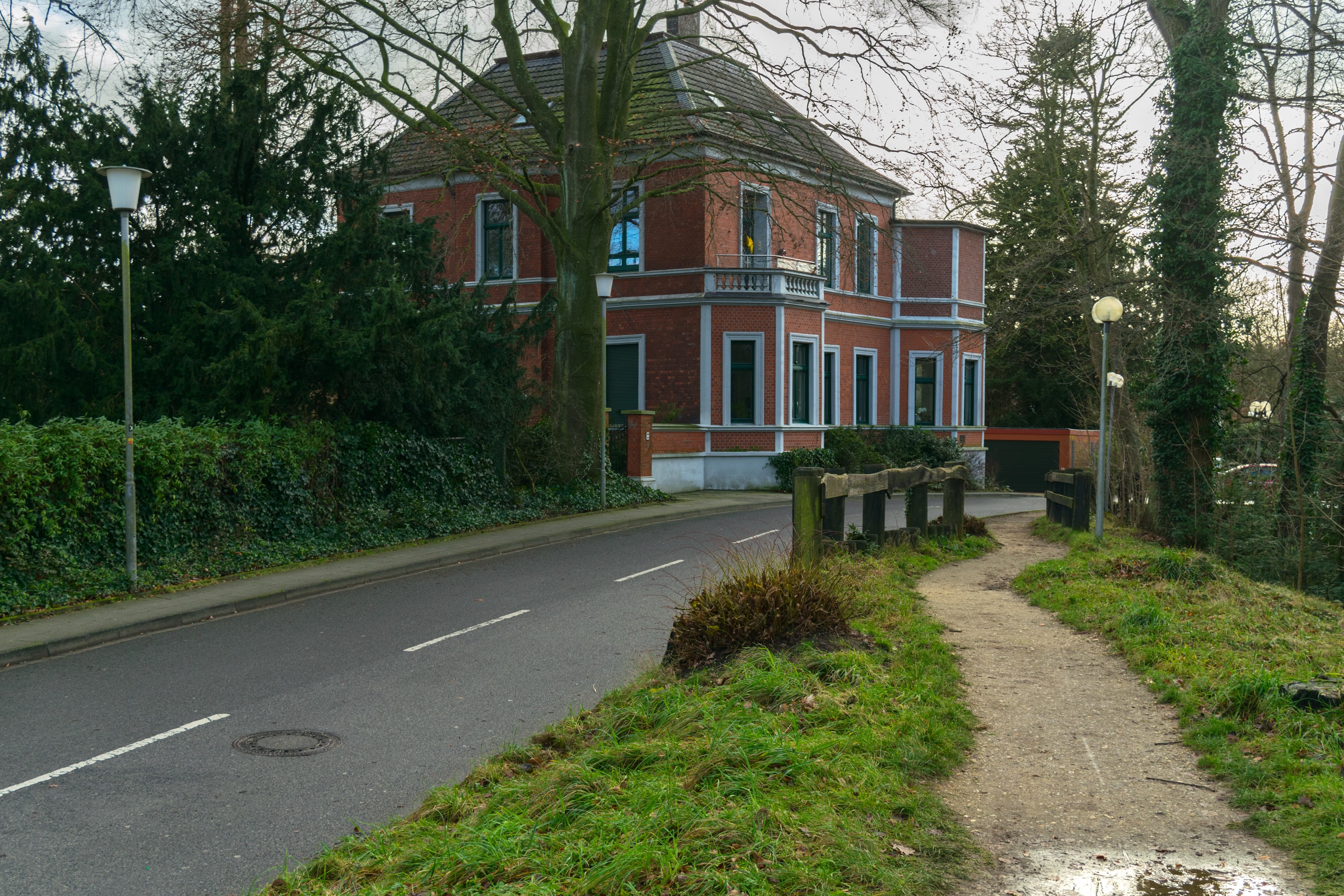 Brick house with a path and a street in Germany HD Wallpaper