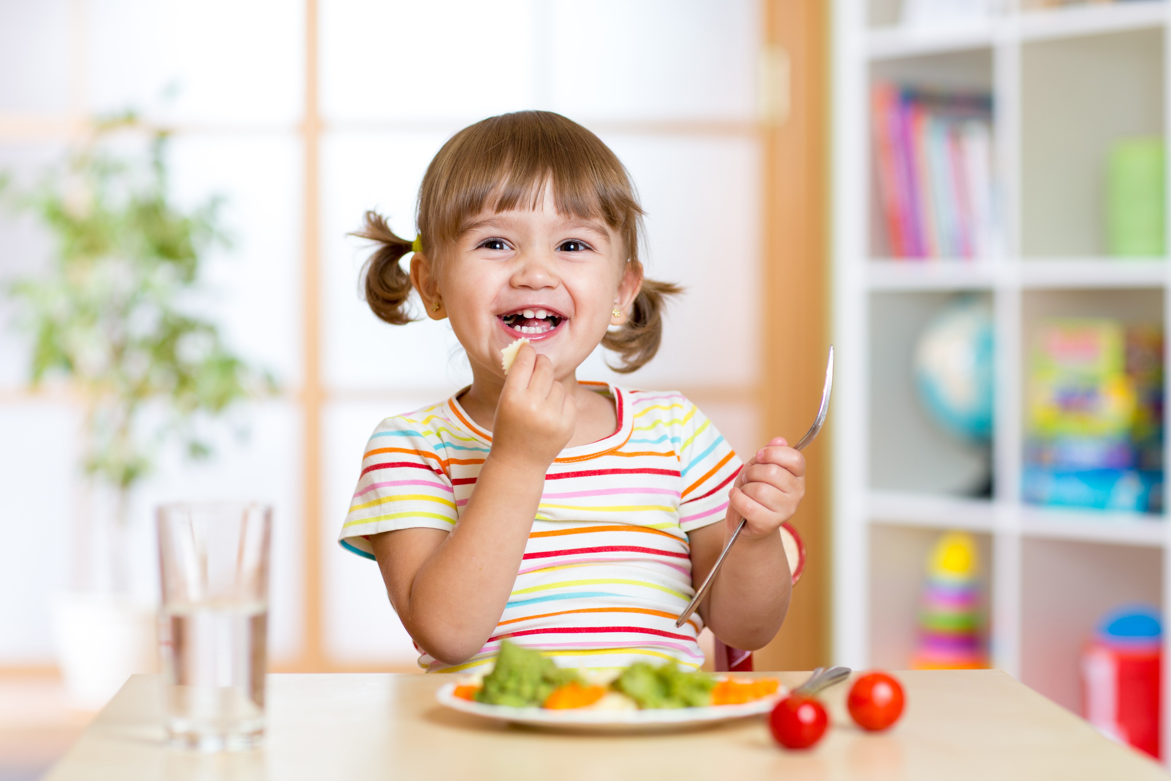 Little girl eating at a table HD Wallpaper