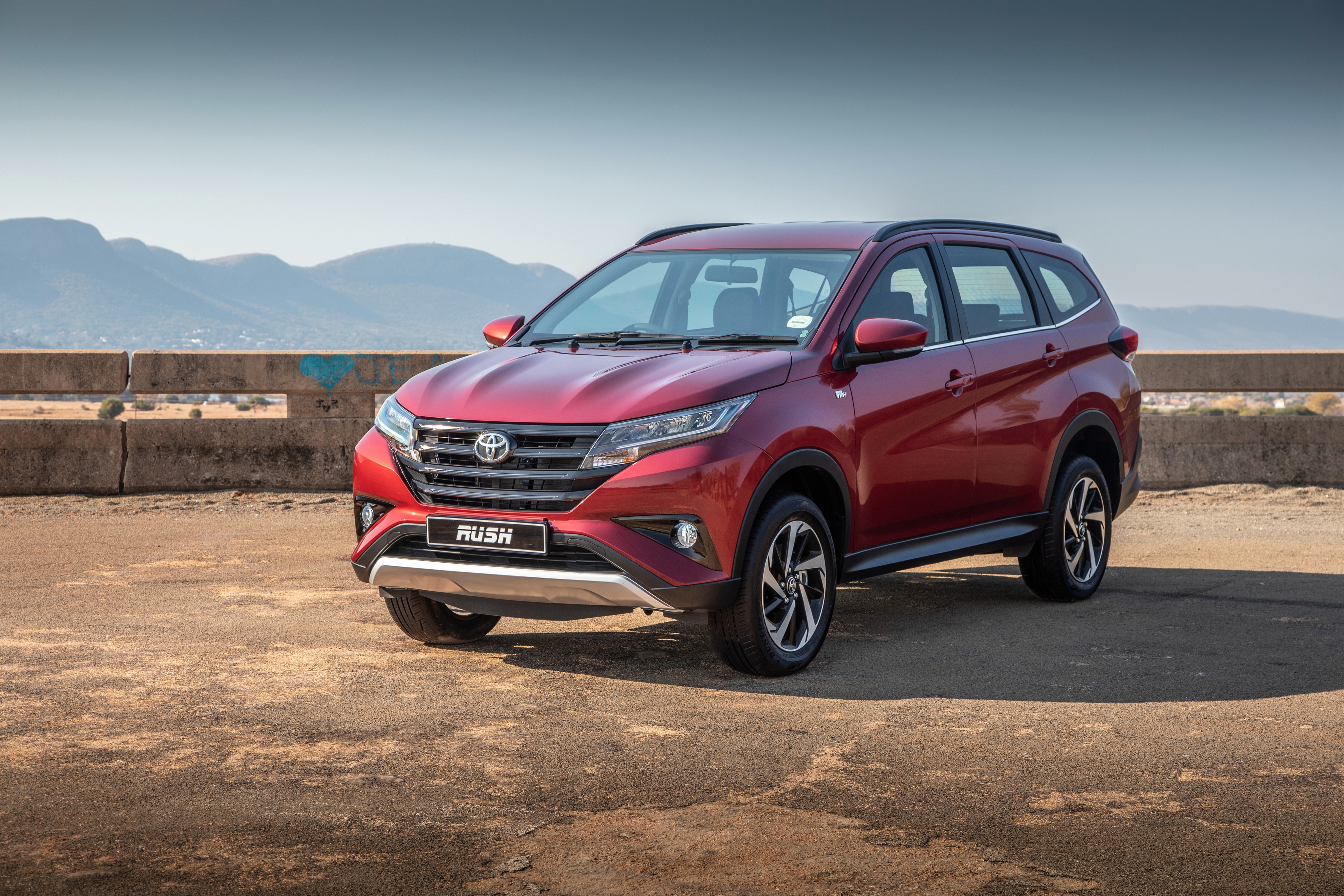 Red Toyota Rush parked outdoors HD Wallpaper