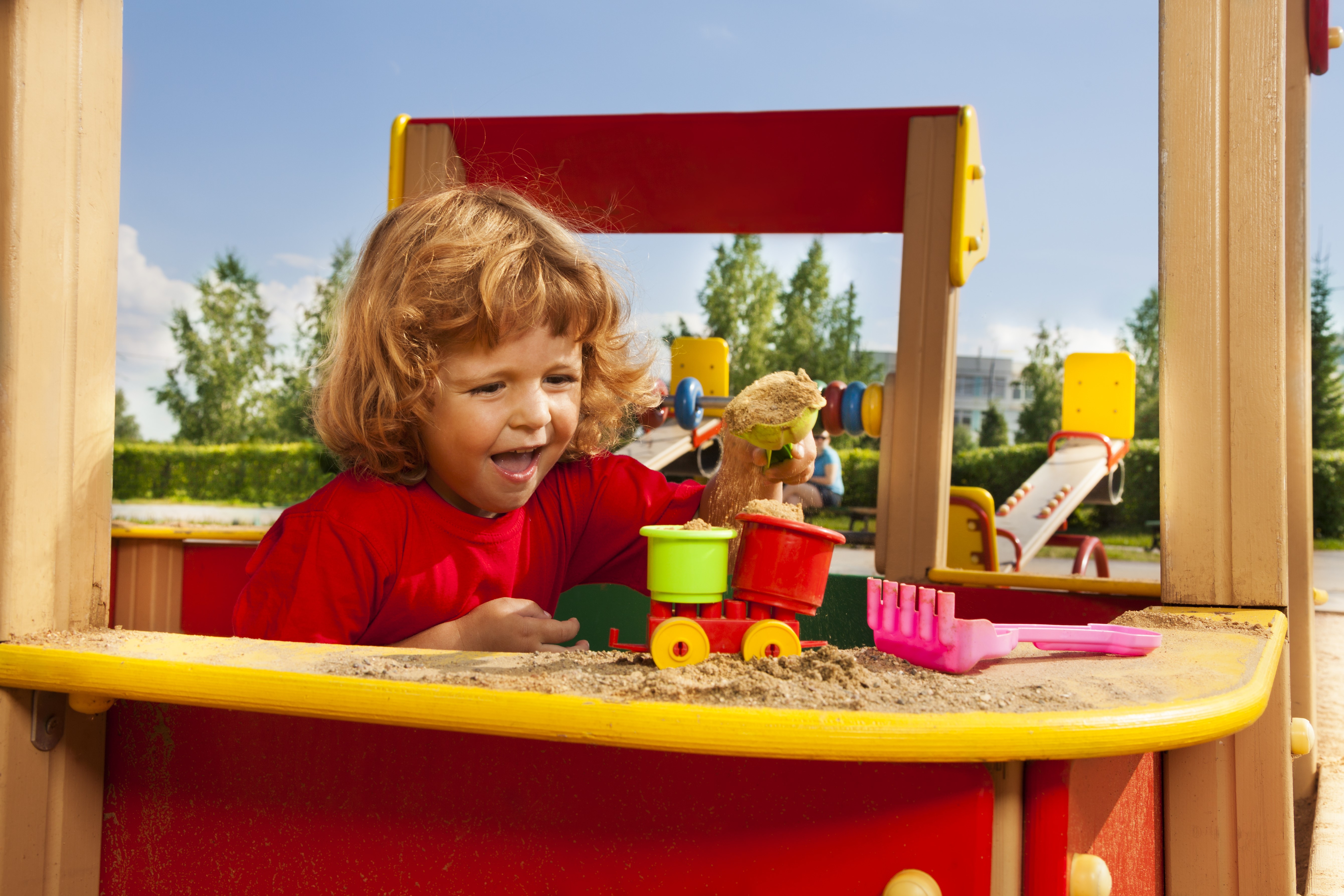 Little girl playing with toys in a sandbox HD Wallpaper