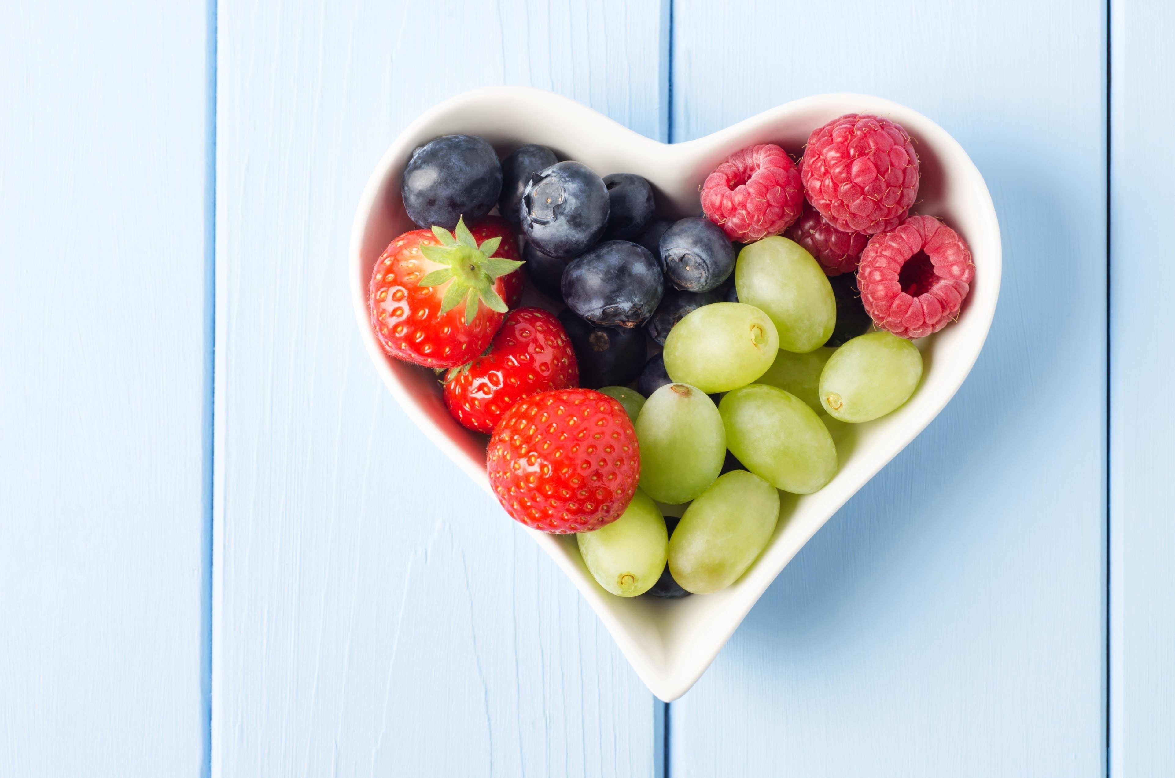 Heart-shaped bowl of berries and grapes HD Wallpaper