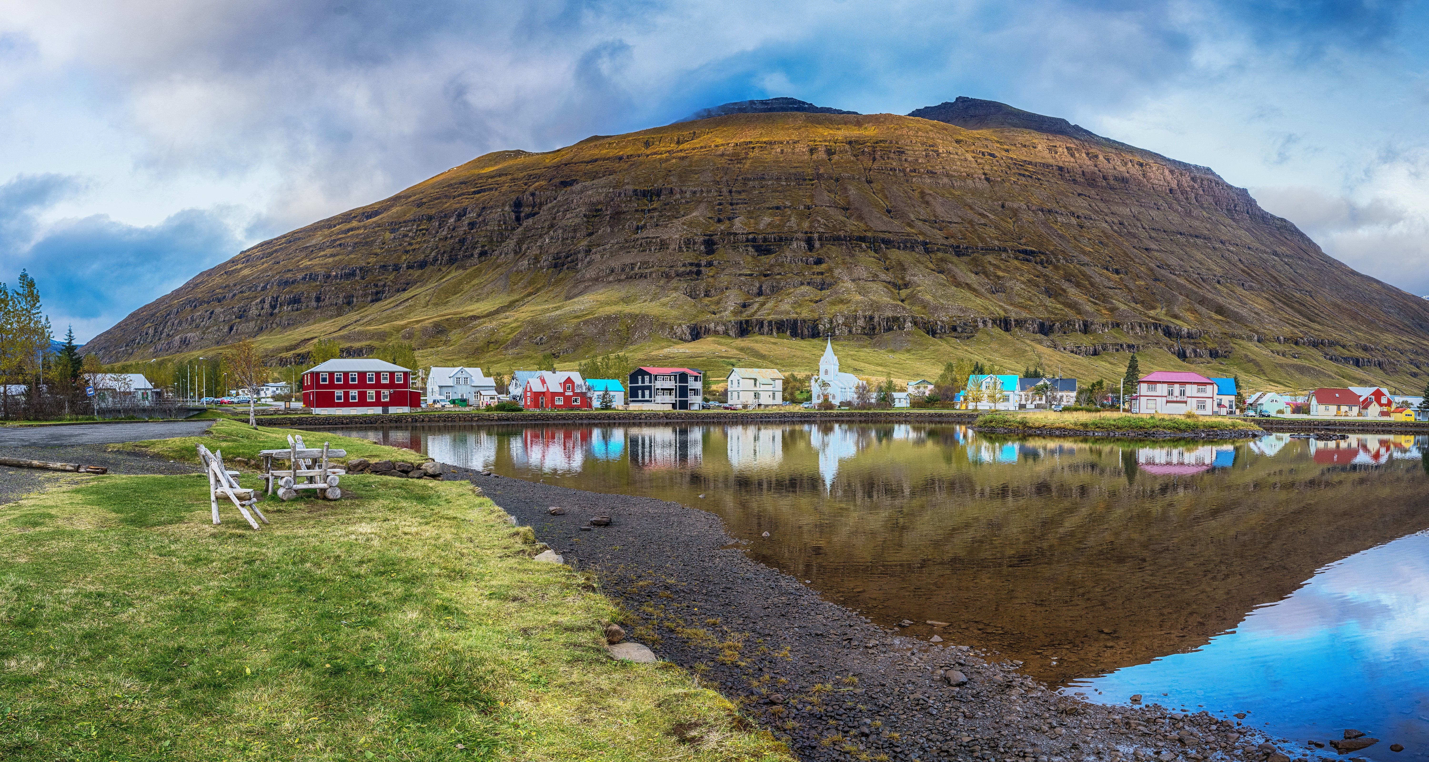 Icelandic village with colorful houses and mountain reflection HD Wallpaper