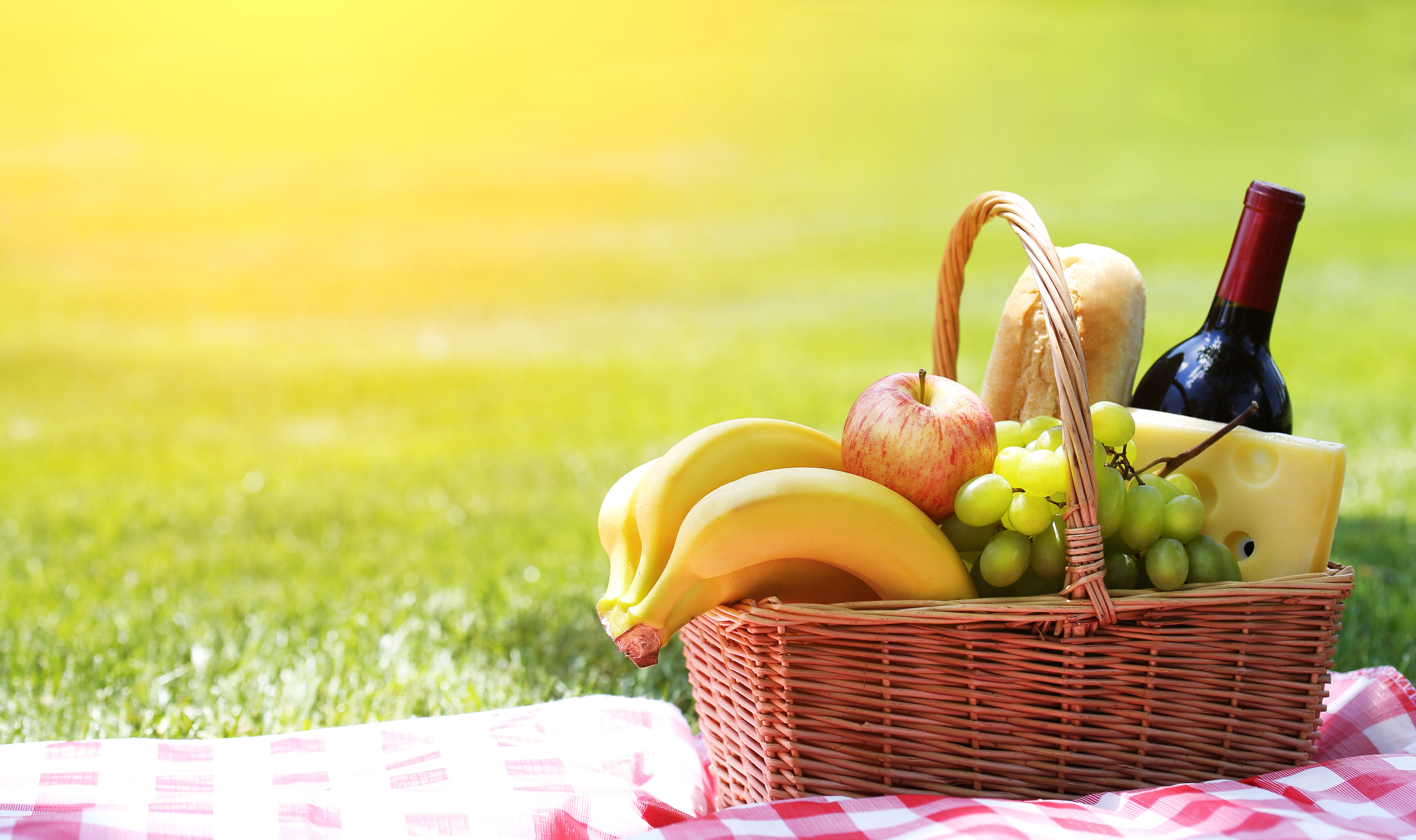 Picnic basket with wine, cheese, bread, and fruit HD Wallpaper