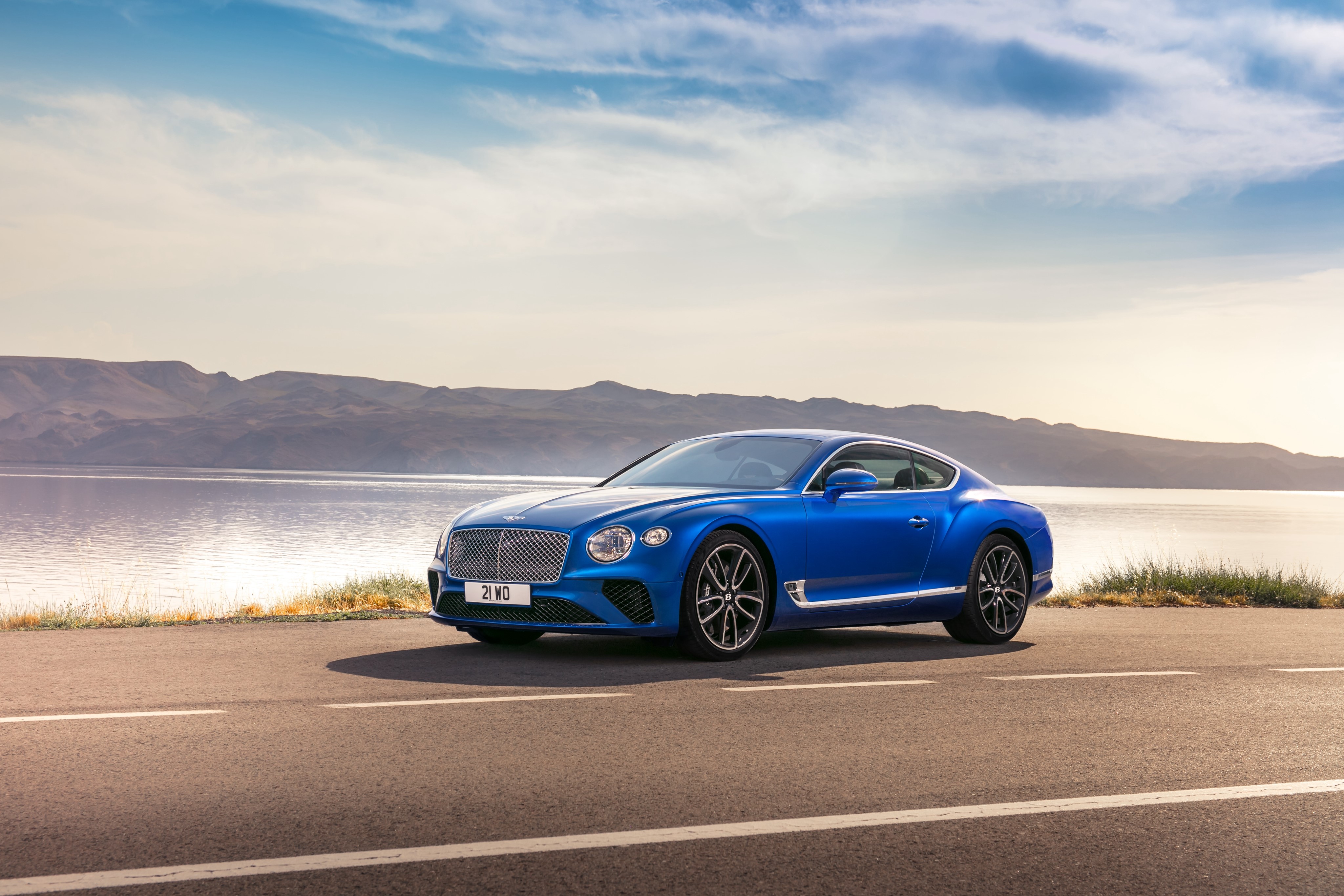 Blue Bentley Continental GT on a road by the water HD Wallpaper