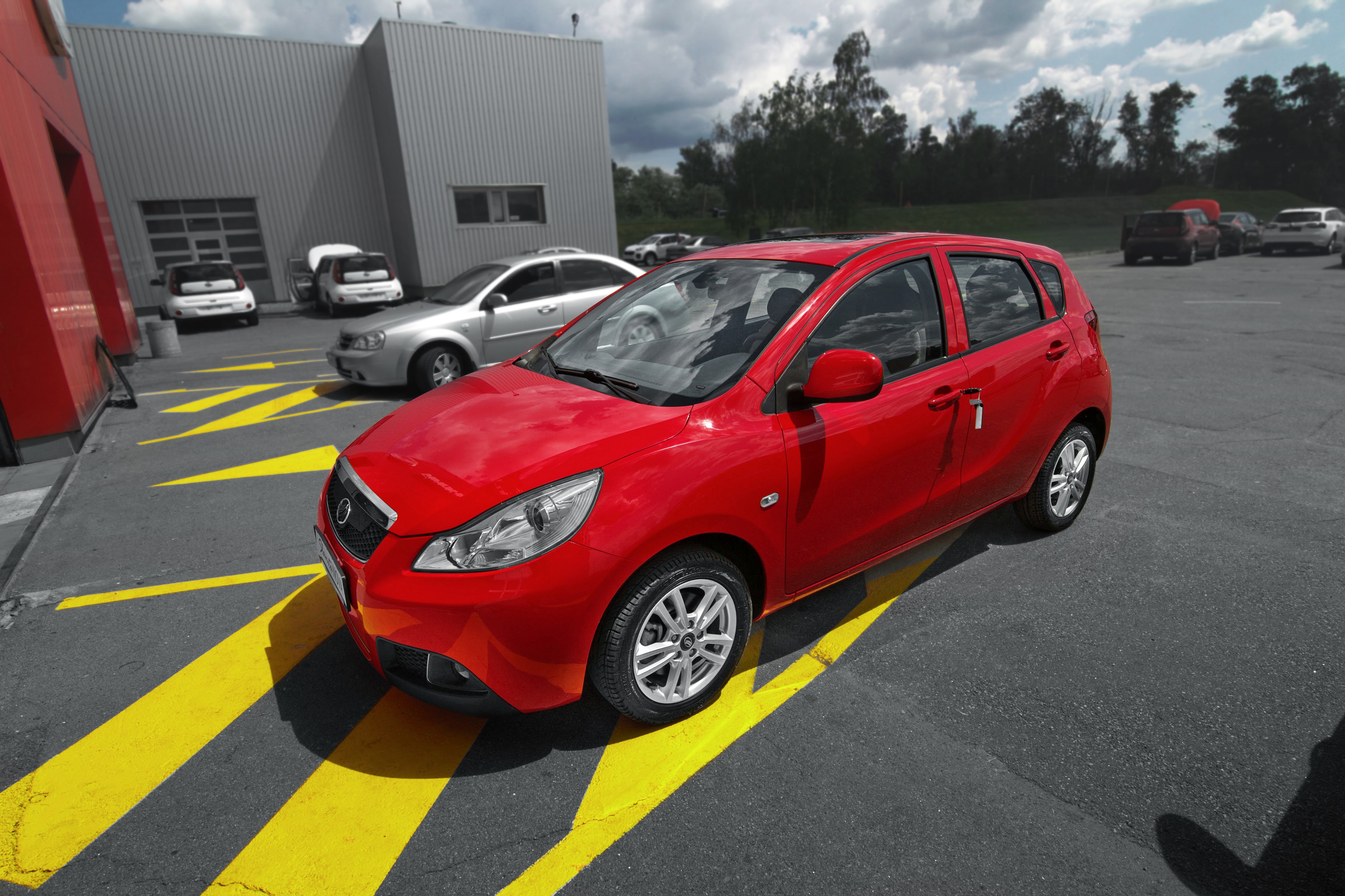 Red 2016 ZAZ Slavuta Nova car parked outside a building HD Wallpaper