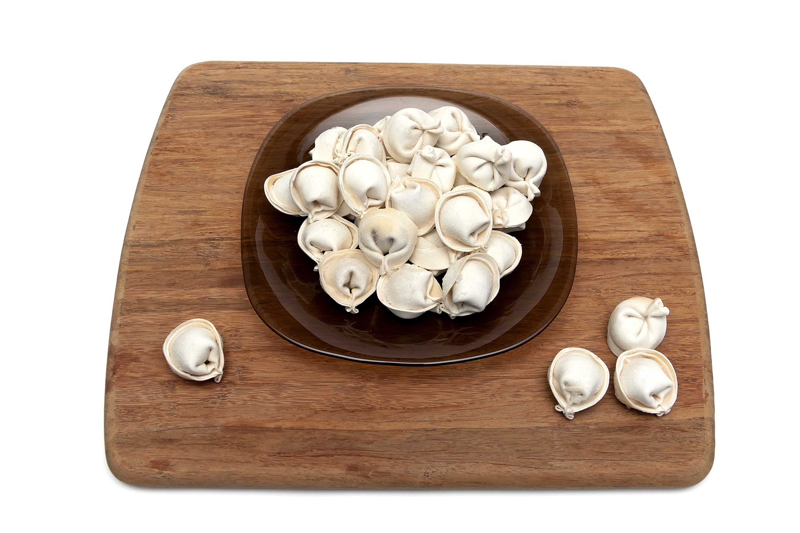 Pelmeni on a wooden cutting board and plate HD Wallpaper