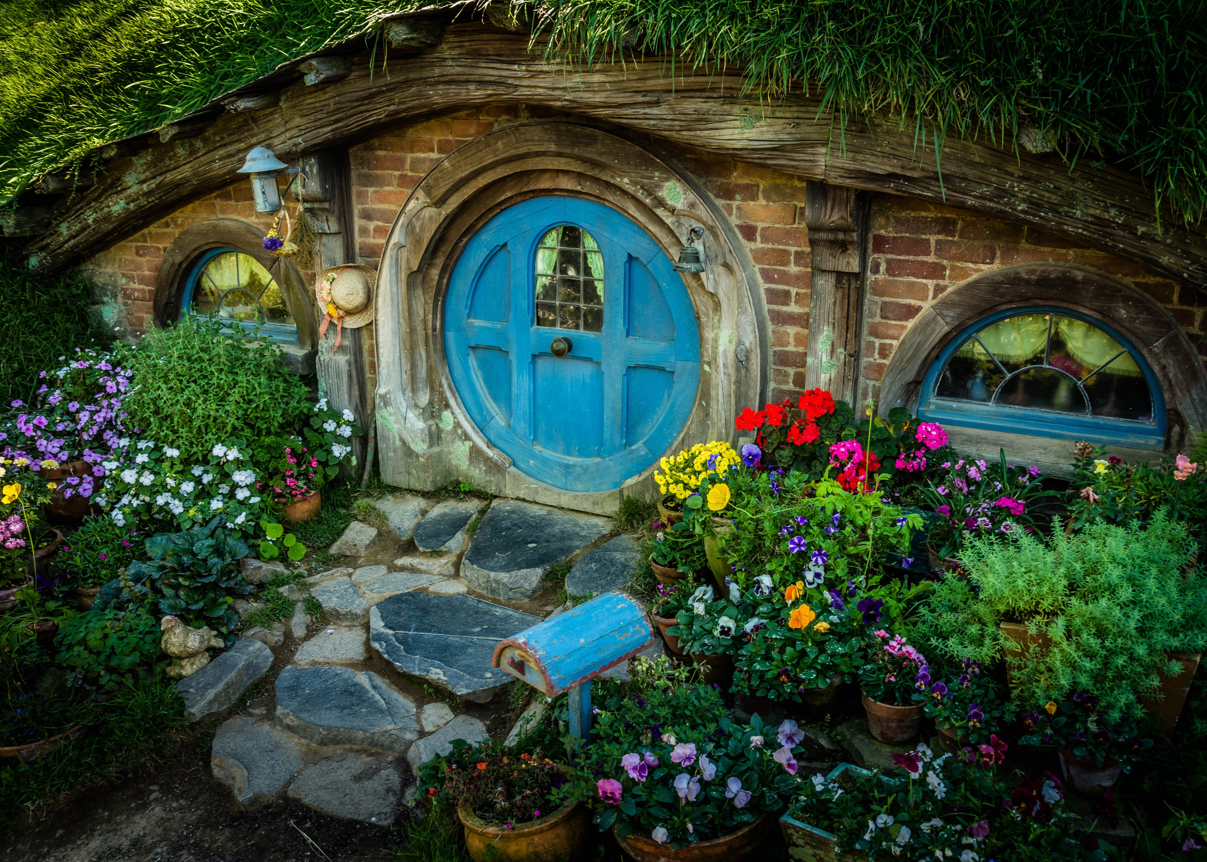 Matamata Hobbit House in New Zealand with Flowers HD Wallpaper