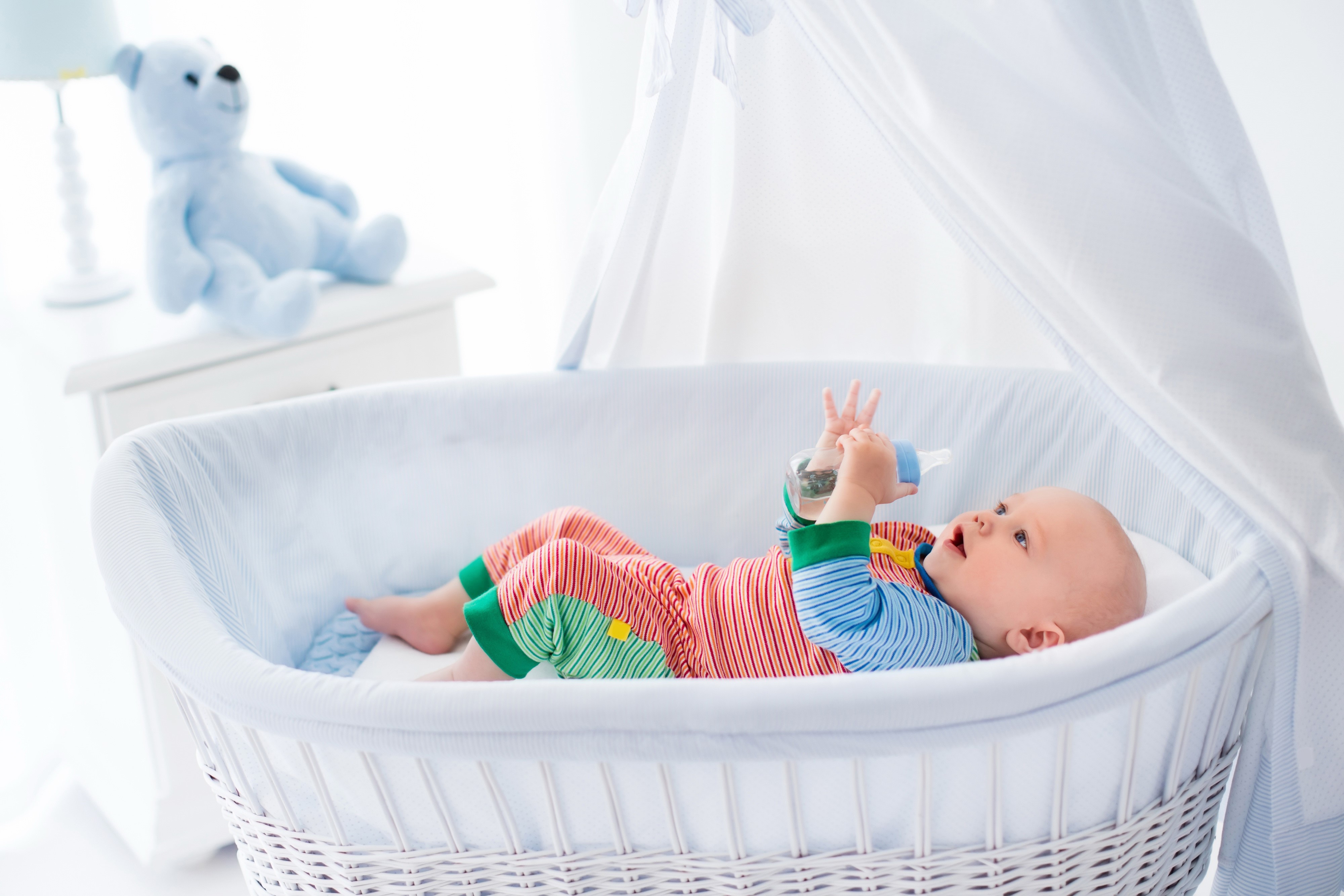 Baby in crib with teddy bear HD Wallpaper