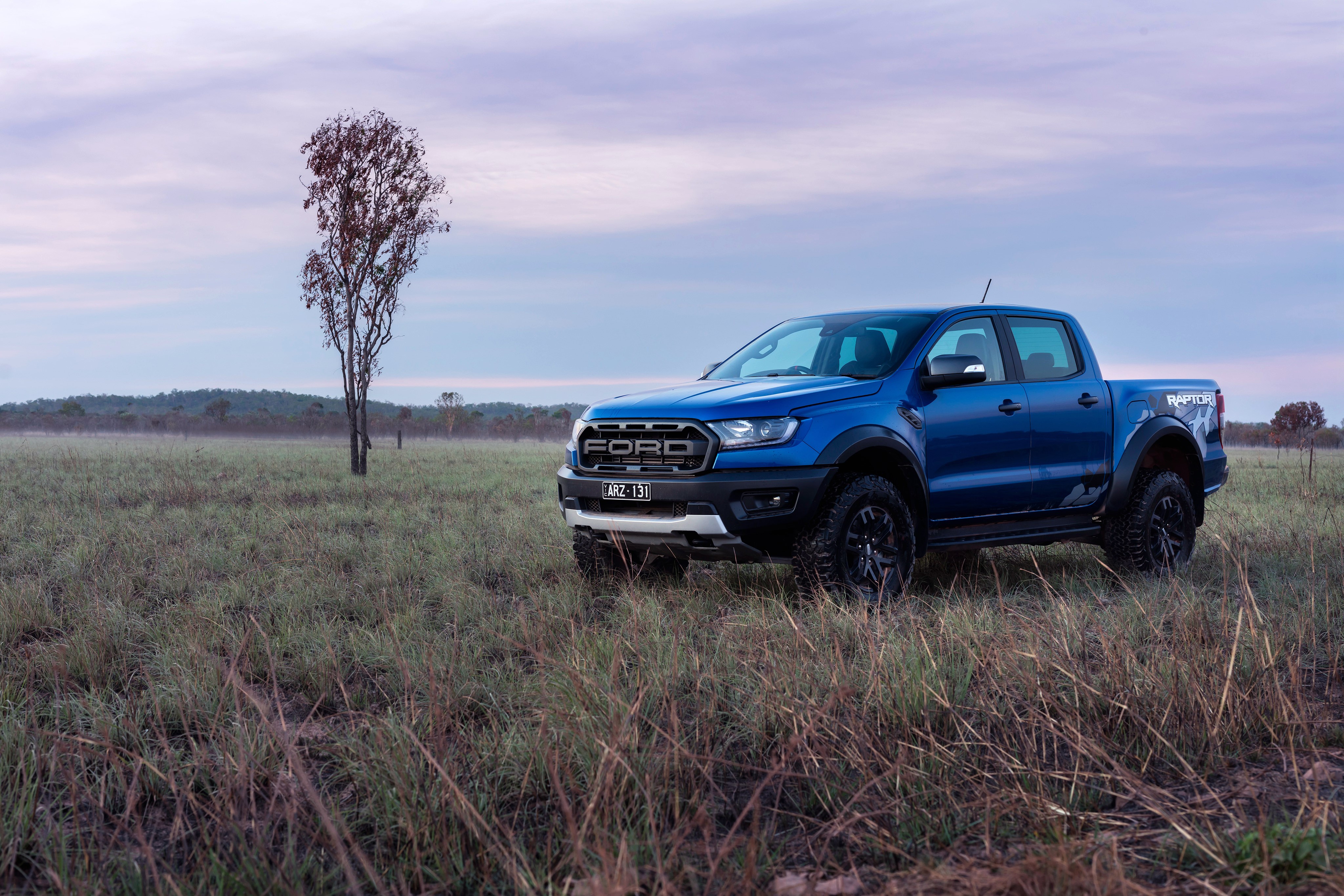 Blue Ford Ranger Raptor pickup truck in a field HD Wallpaper