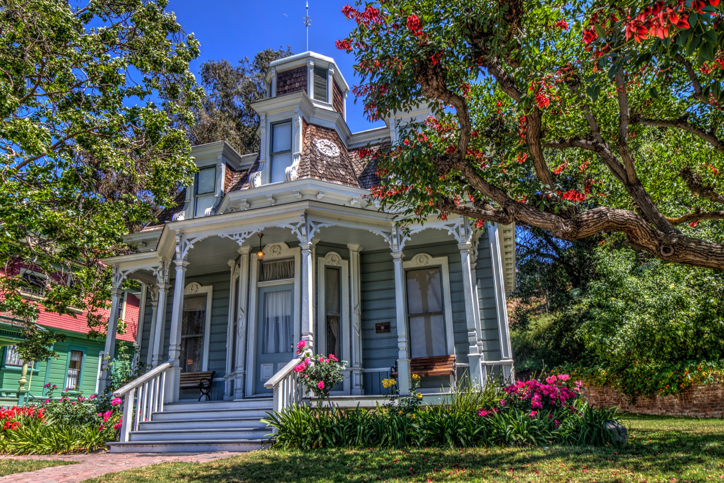 Victorian House with Red Flowers and Greenery HD Wallpaper