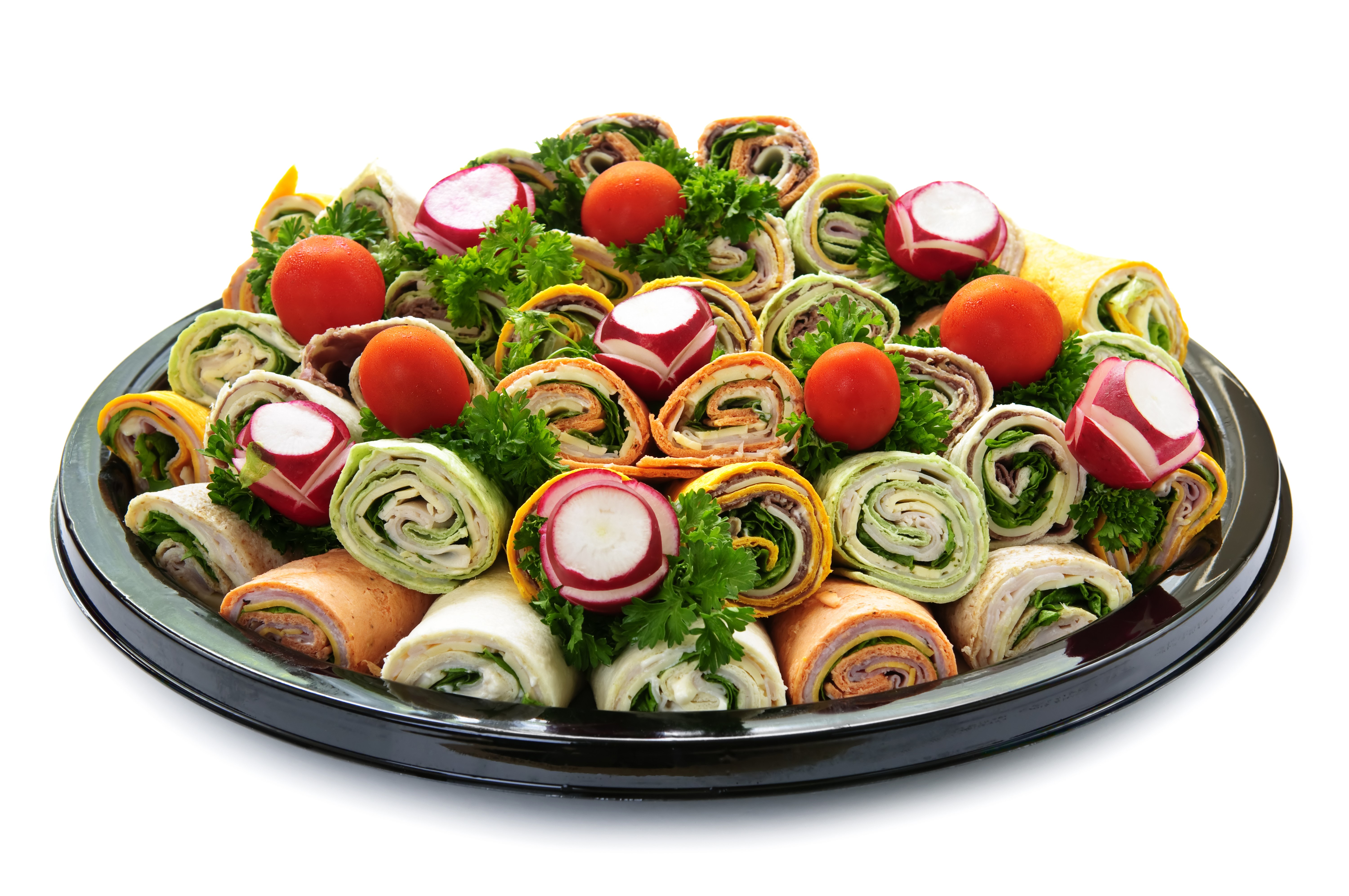 Platter of assorted pinwheel wraps with tomatoes and radishes HD Wallpaper
