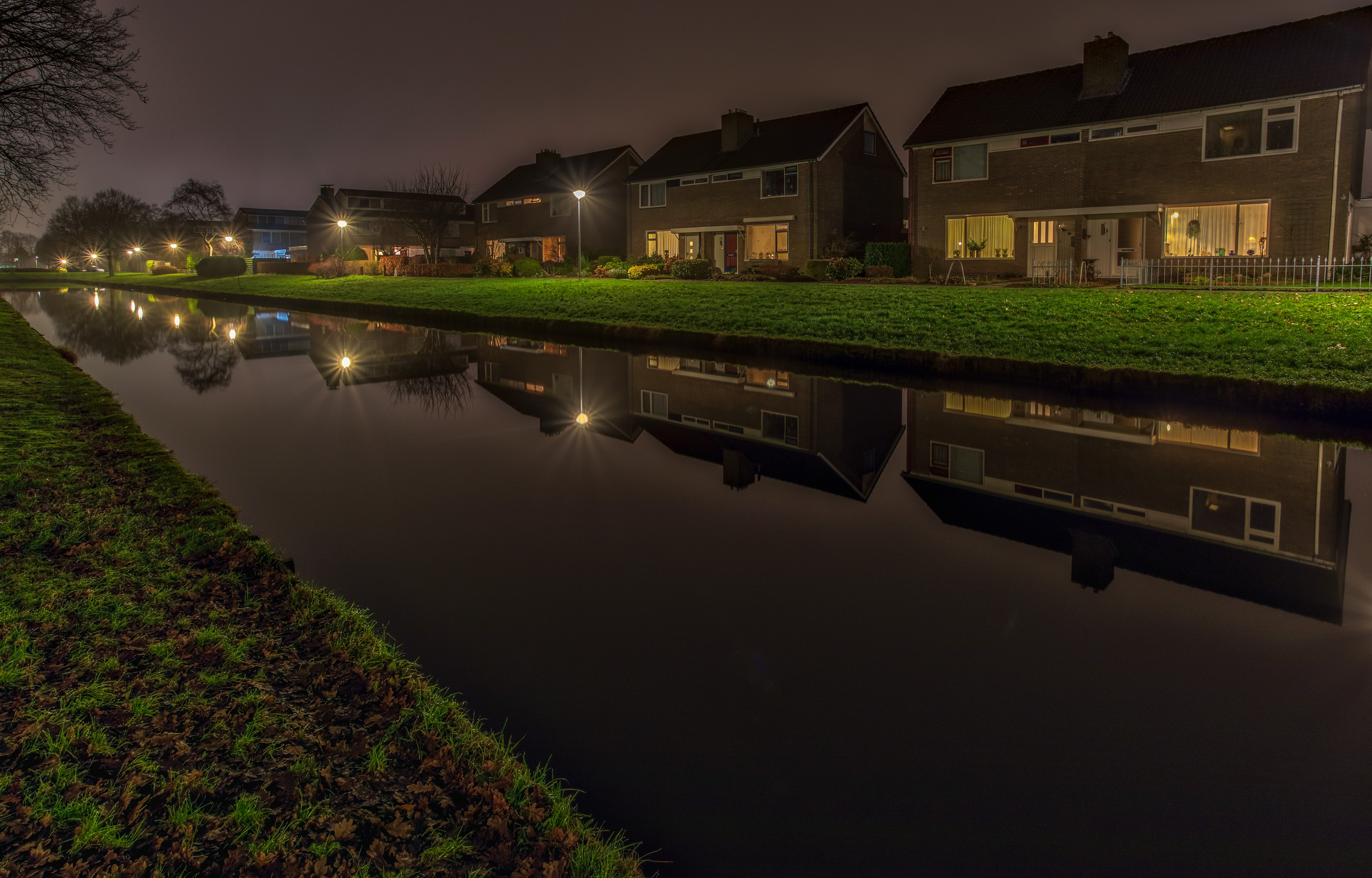 Houses along a canal at night in Groningen, Netherlands HD Wallpaper