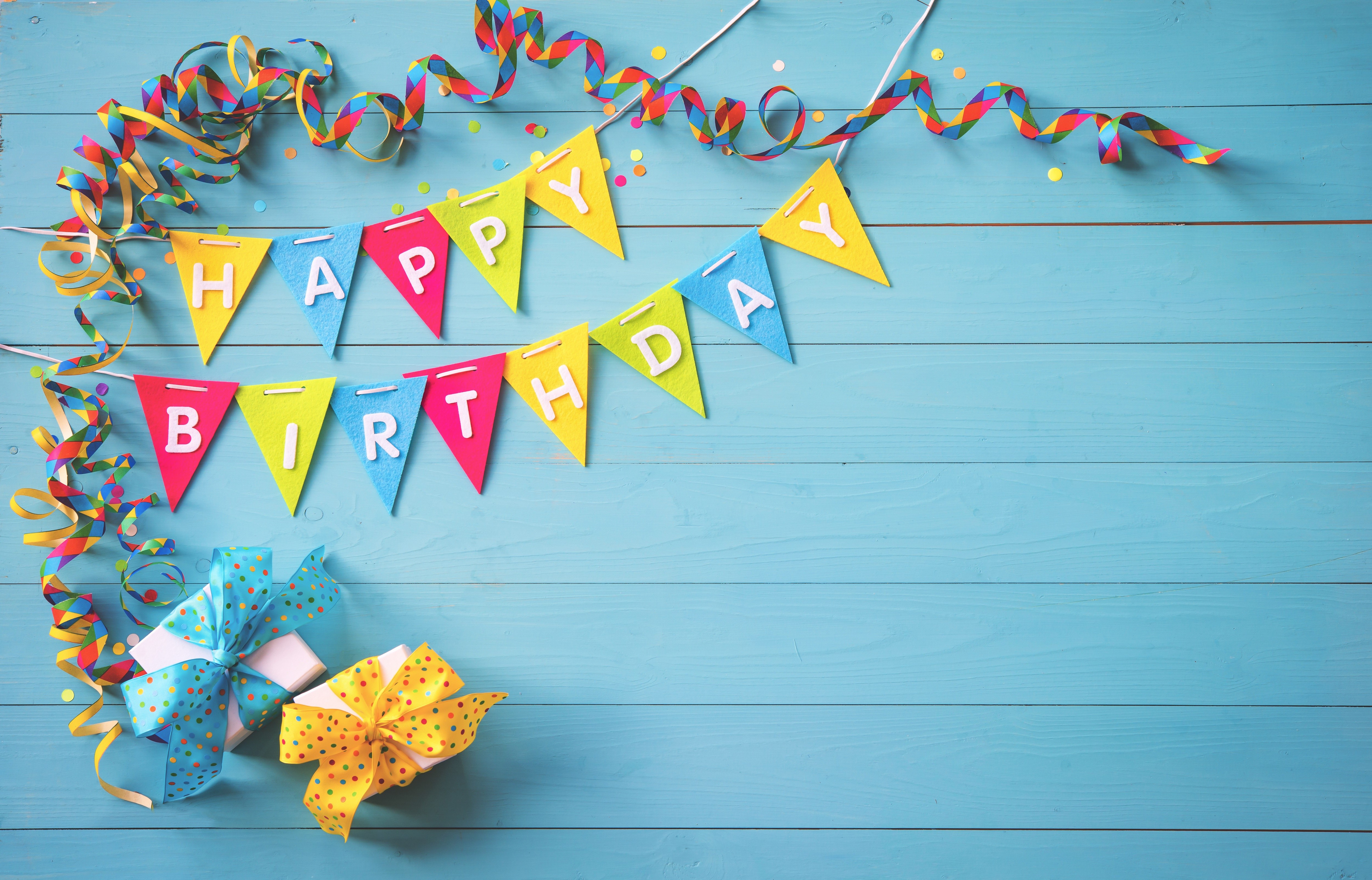 Birthday banner and gifts on wood planks HD Wallpaper